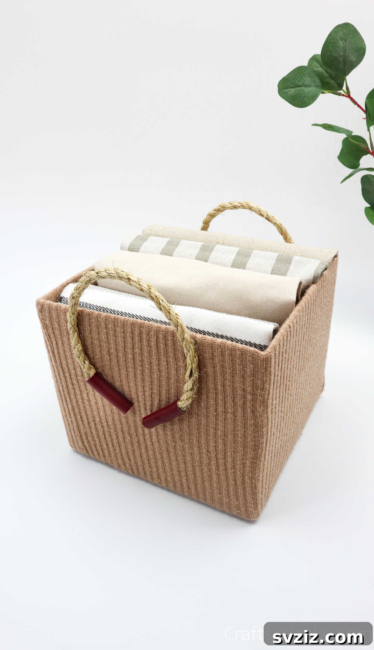Cozy upcycled storage box made from an old sweater and cardboard