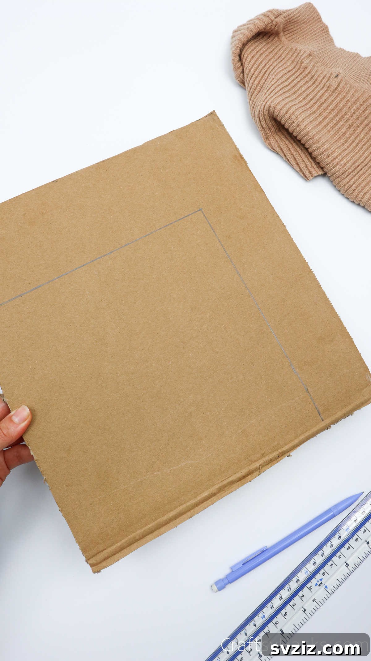 Tracing the box base shape onto cardboard