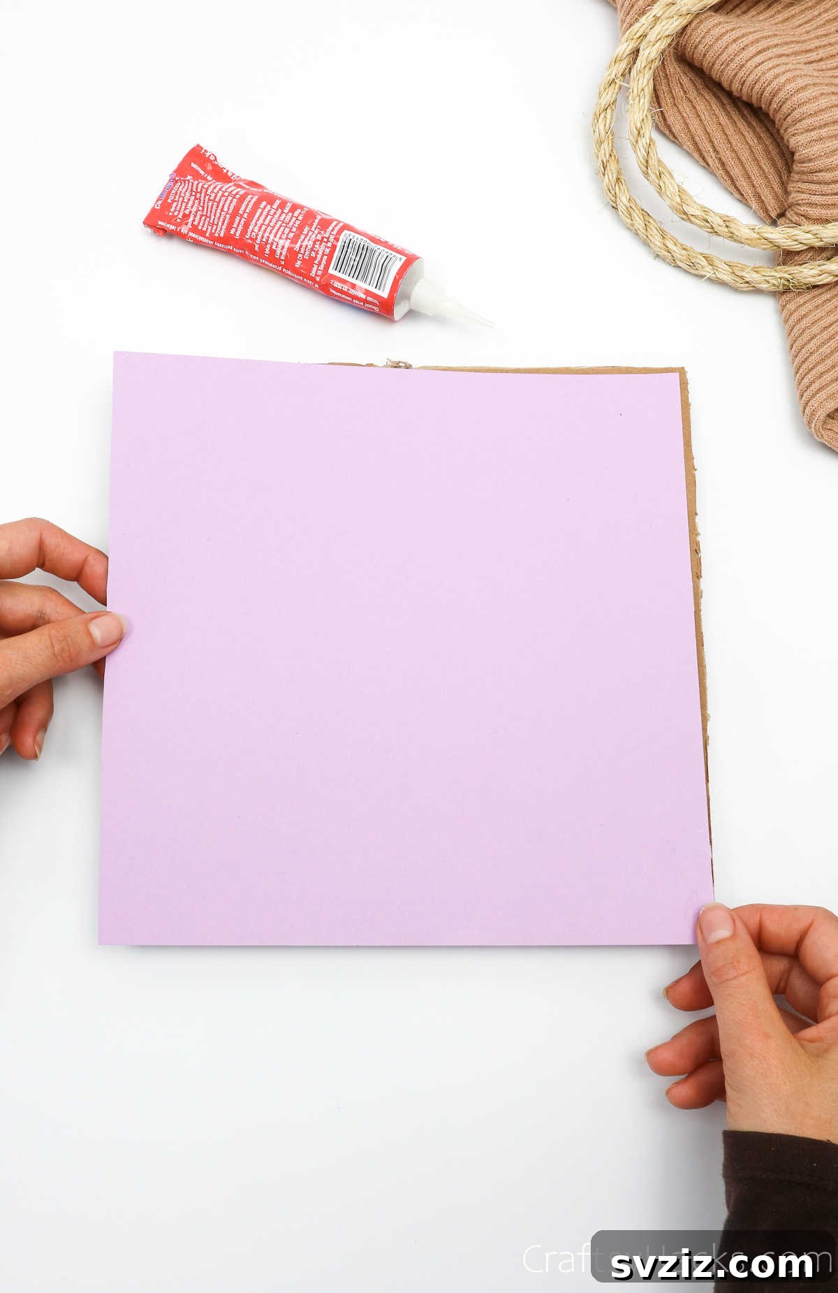 Decorative paper being glued onto cardboard