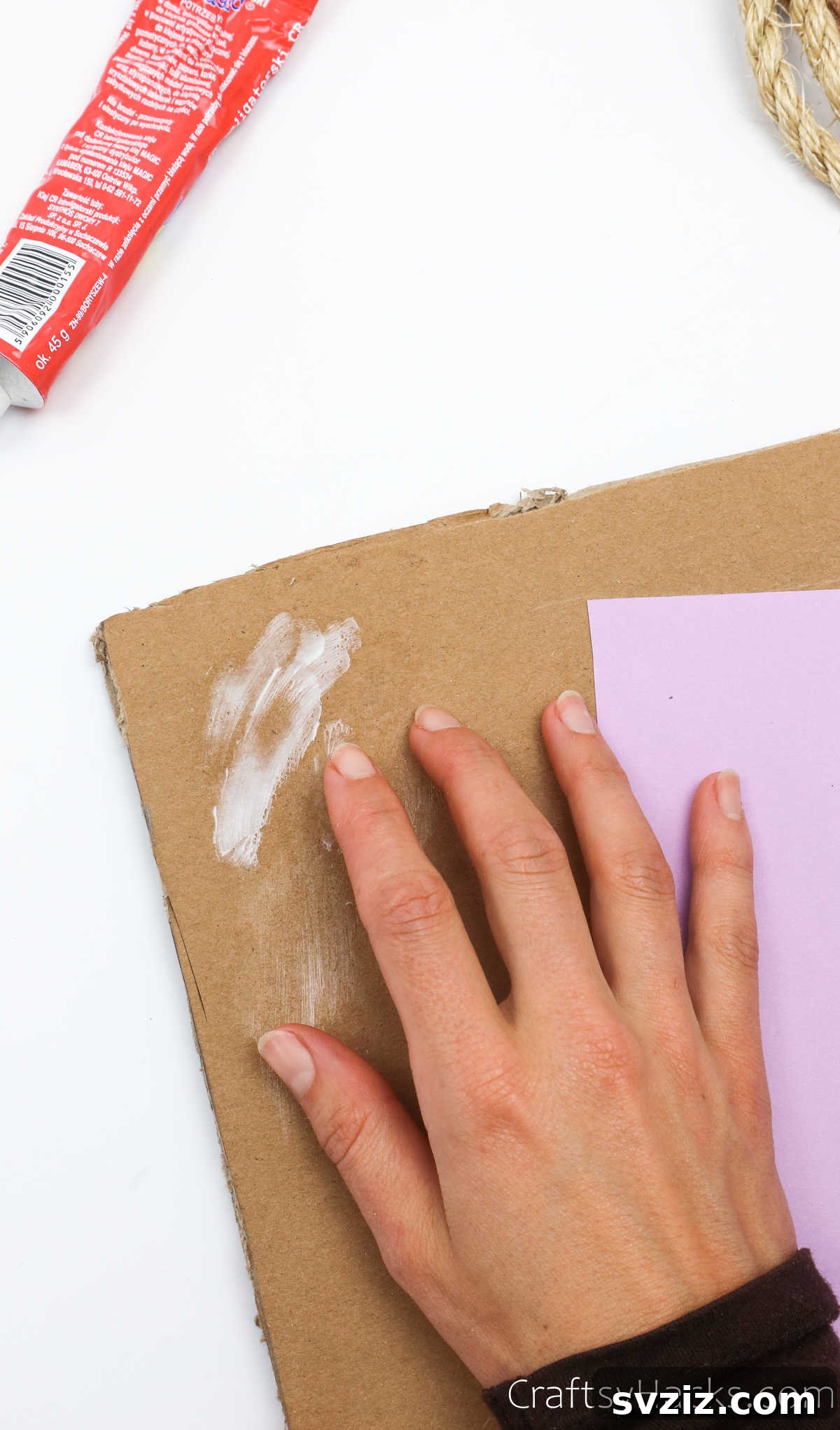 Applying glue to the cardboard piece