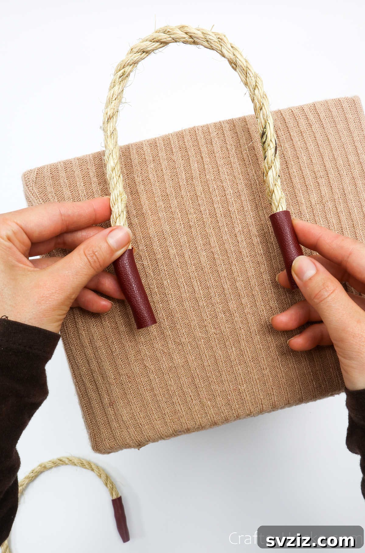 Securing one end of a rope handle with hot glue