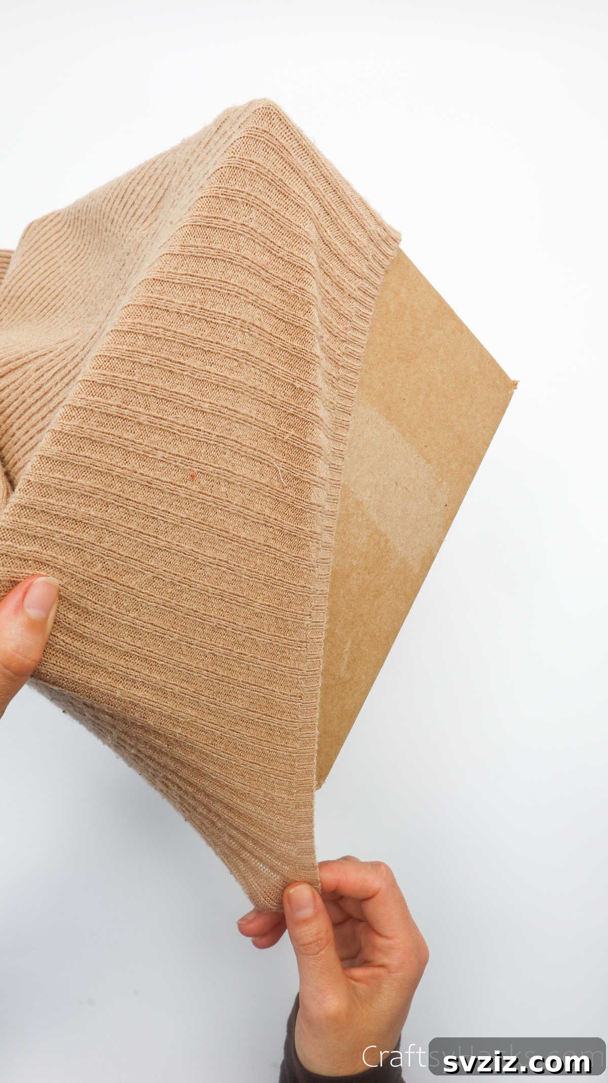 Stretching a sweater over a cardboard box
