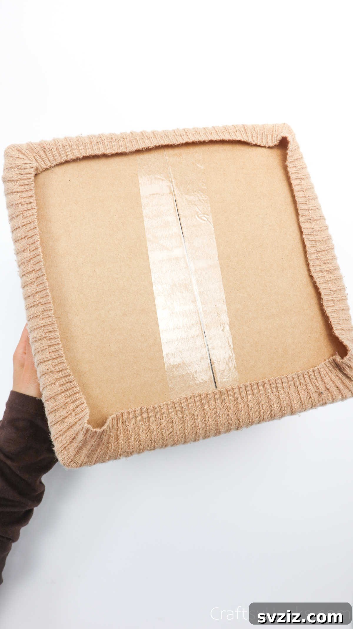 Bottom of a box with sweater fabric taped or held in place