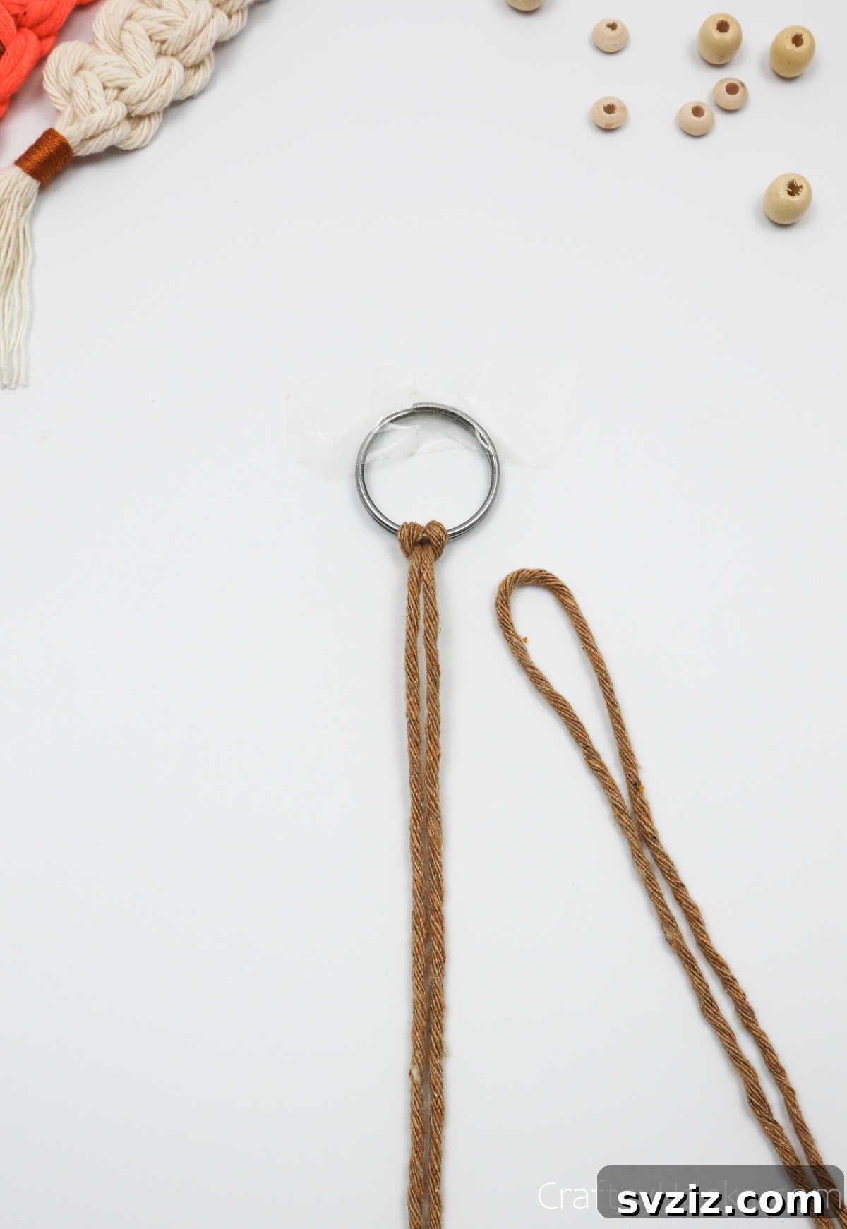 Another macrame cord folded and ready to be attached to the key ring.
