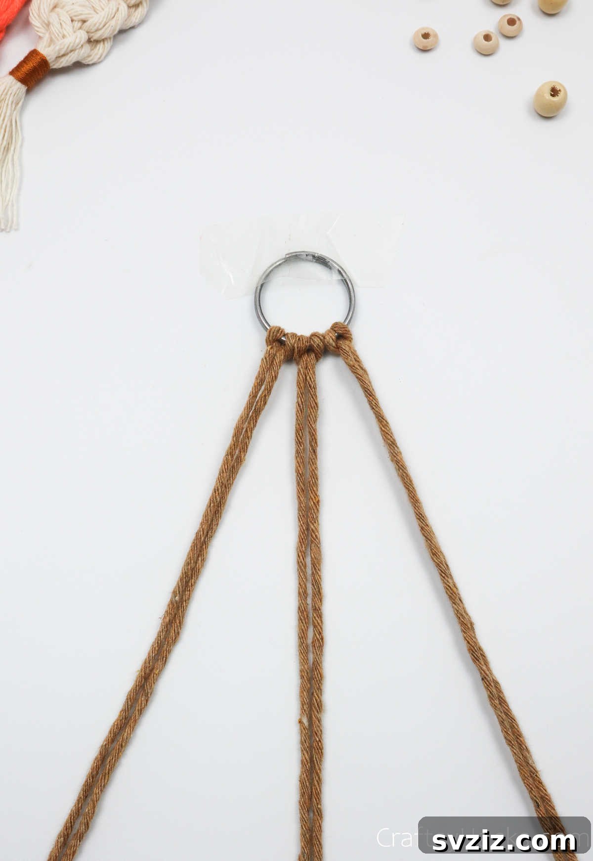 All three macrame cords secured to the key ring with lark's head knots.