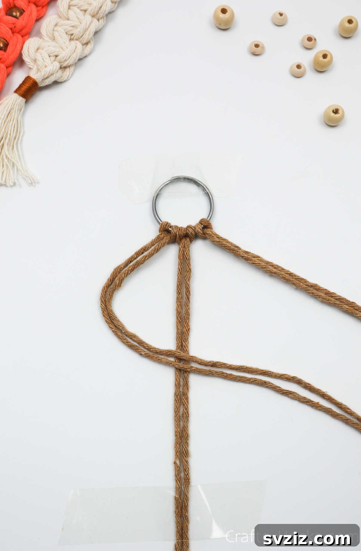 The left two macrame cords are folded over the middle cords, forming a '4' shape.