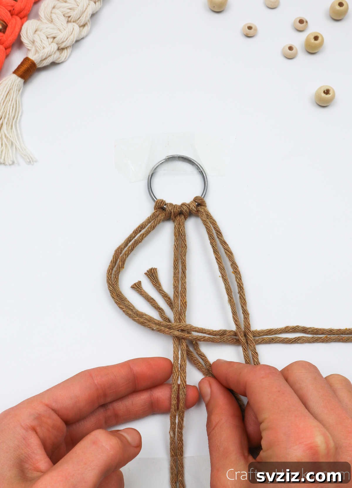 The right cords are pulled under the middle cords and through the left-side loop.