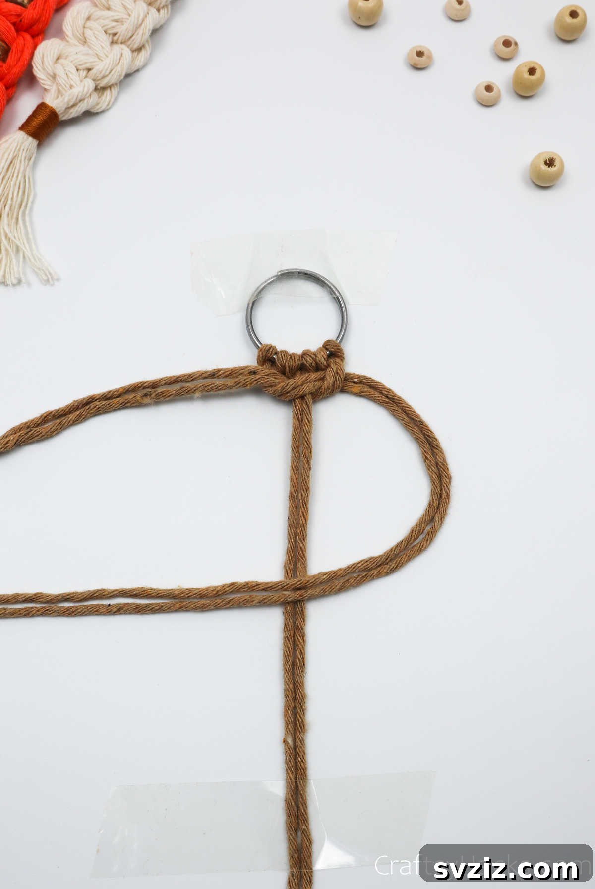 The right two macrame cords are folded over the middle cords to form the second half of the square knot.