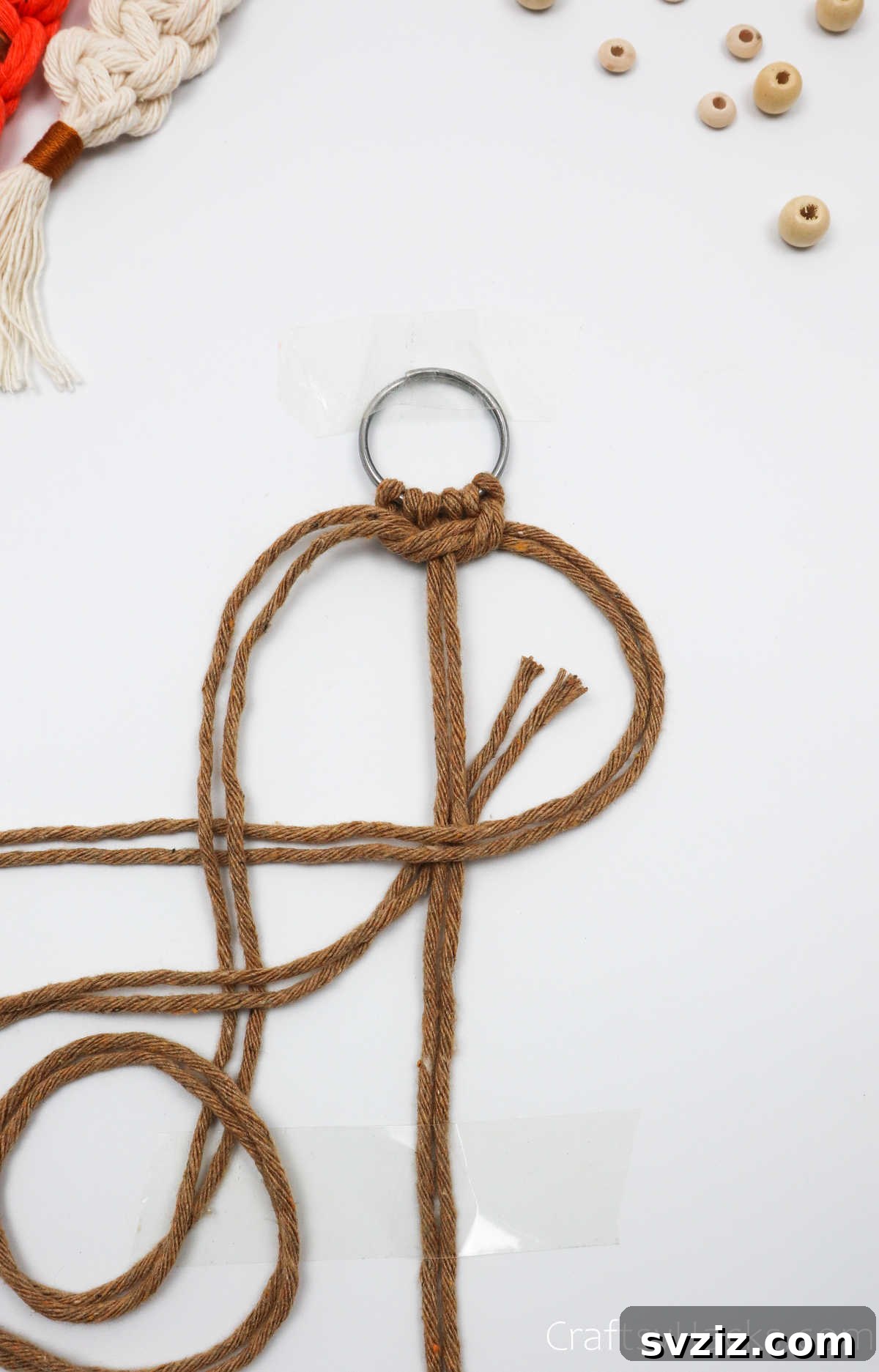 The left cords are pulled under the middle and right cords and through the right-side loop.