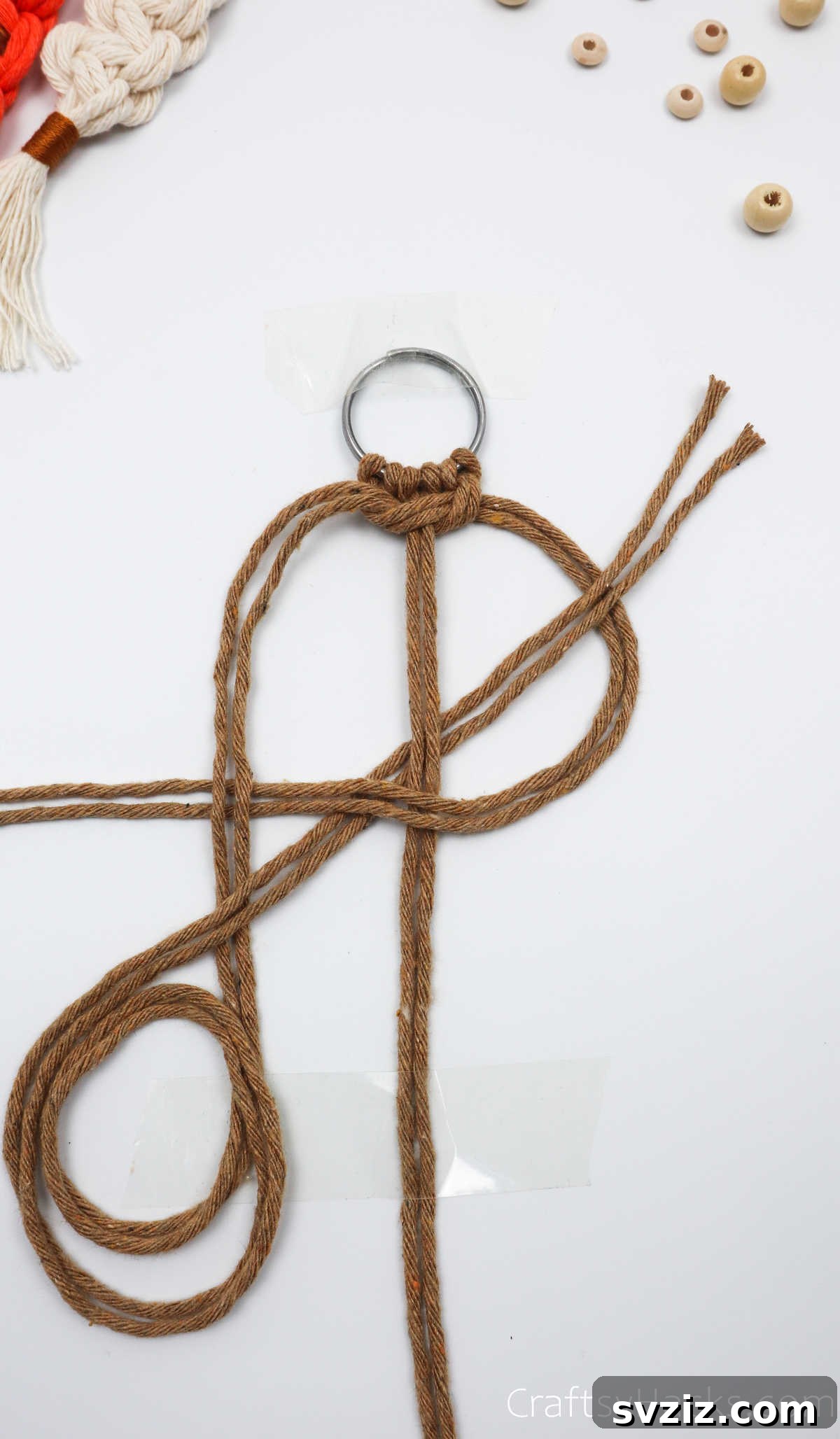 The left cords emerging from the loop, ready to be tightened to complete the square knot.