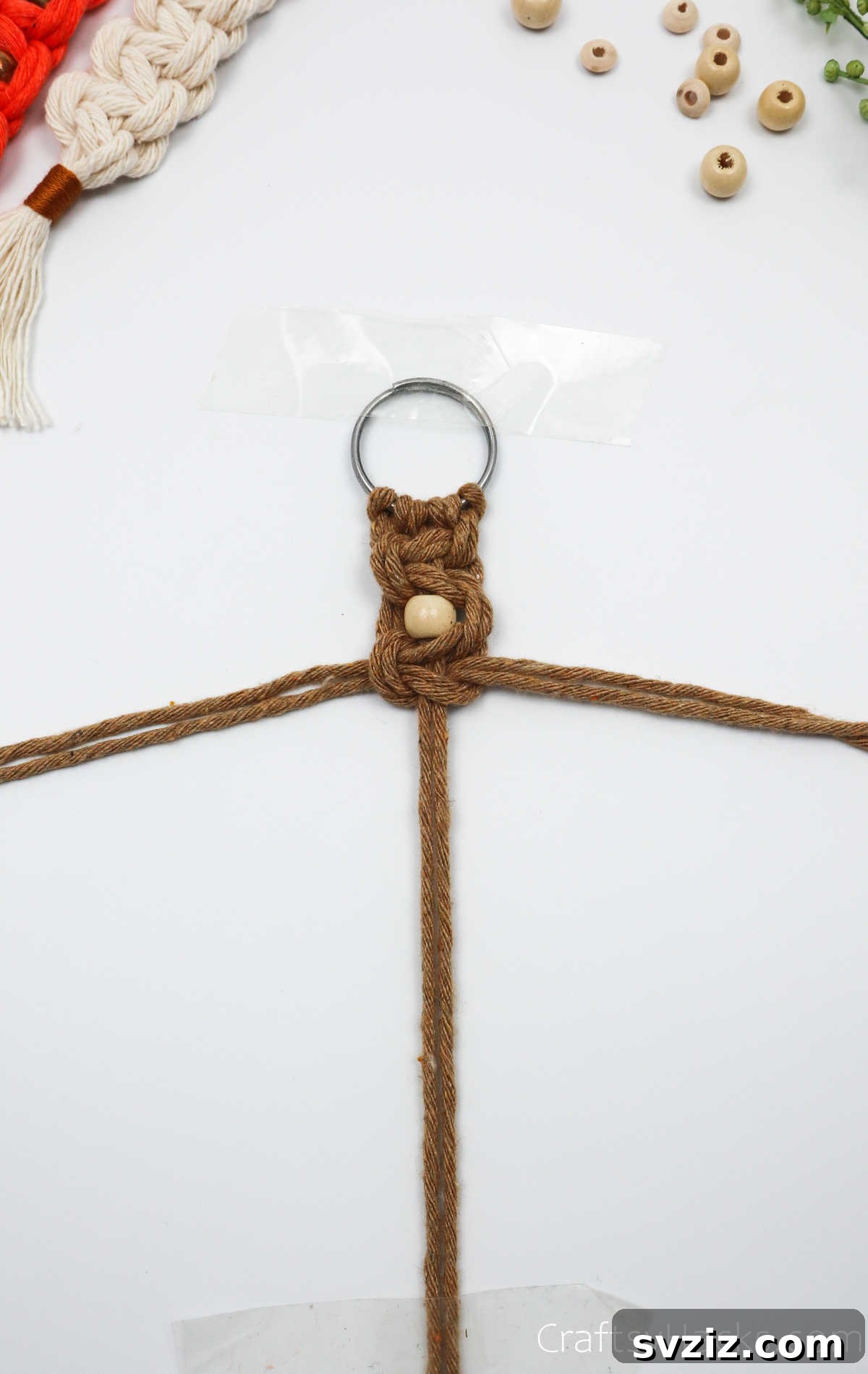 A section of the macrame keychain with a bead securely framed by two square knots.