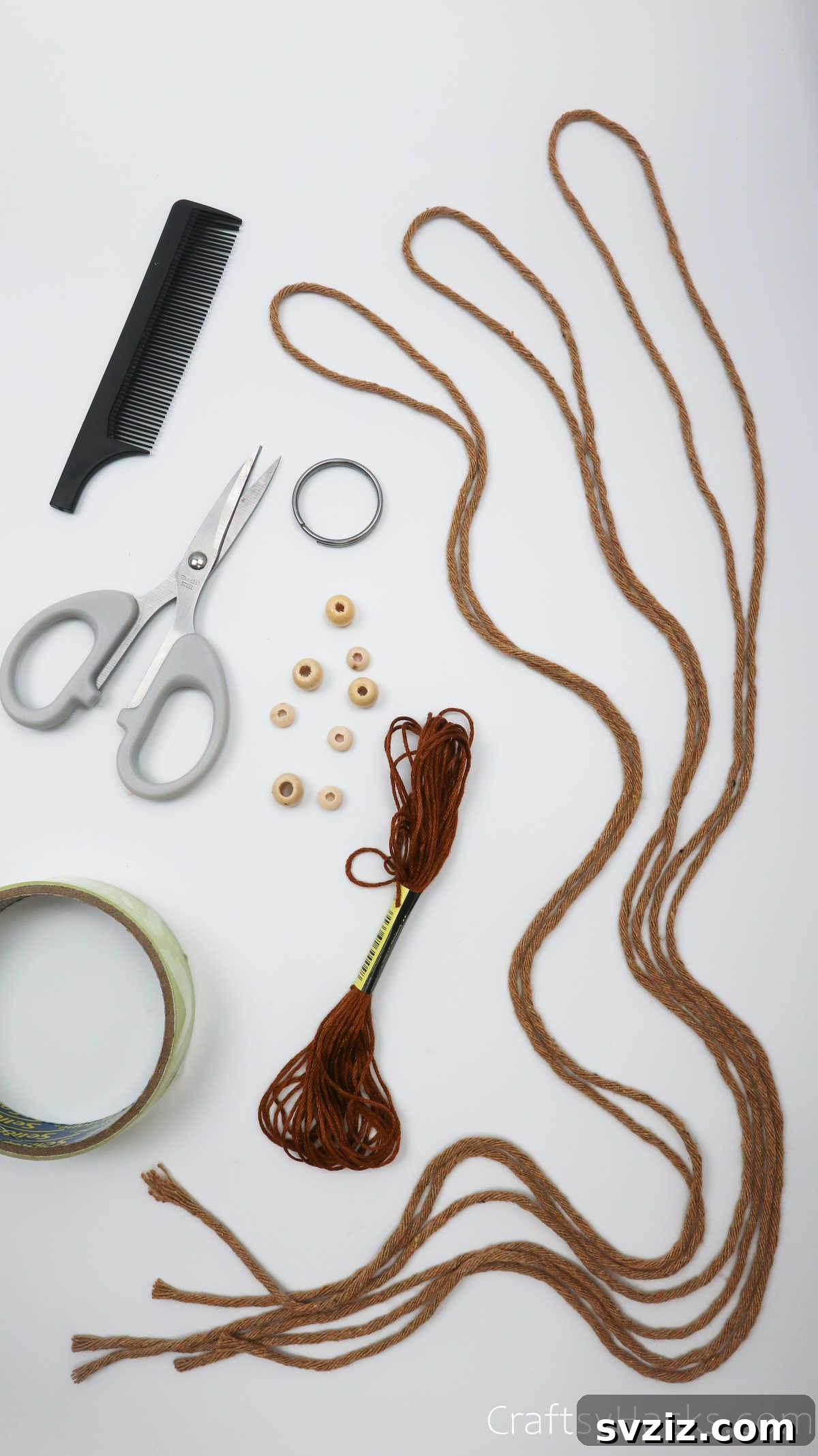All macrame craft supplies neatly laid out, including cords, beads, key rings, and tools.
