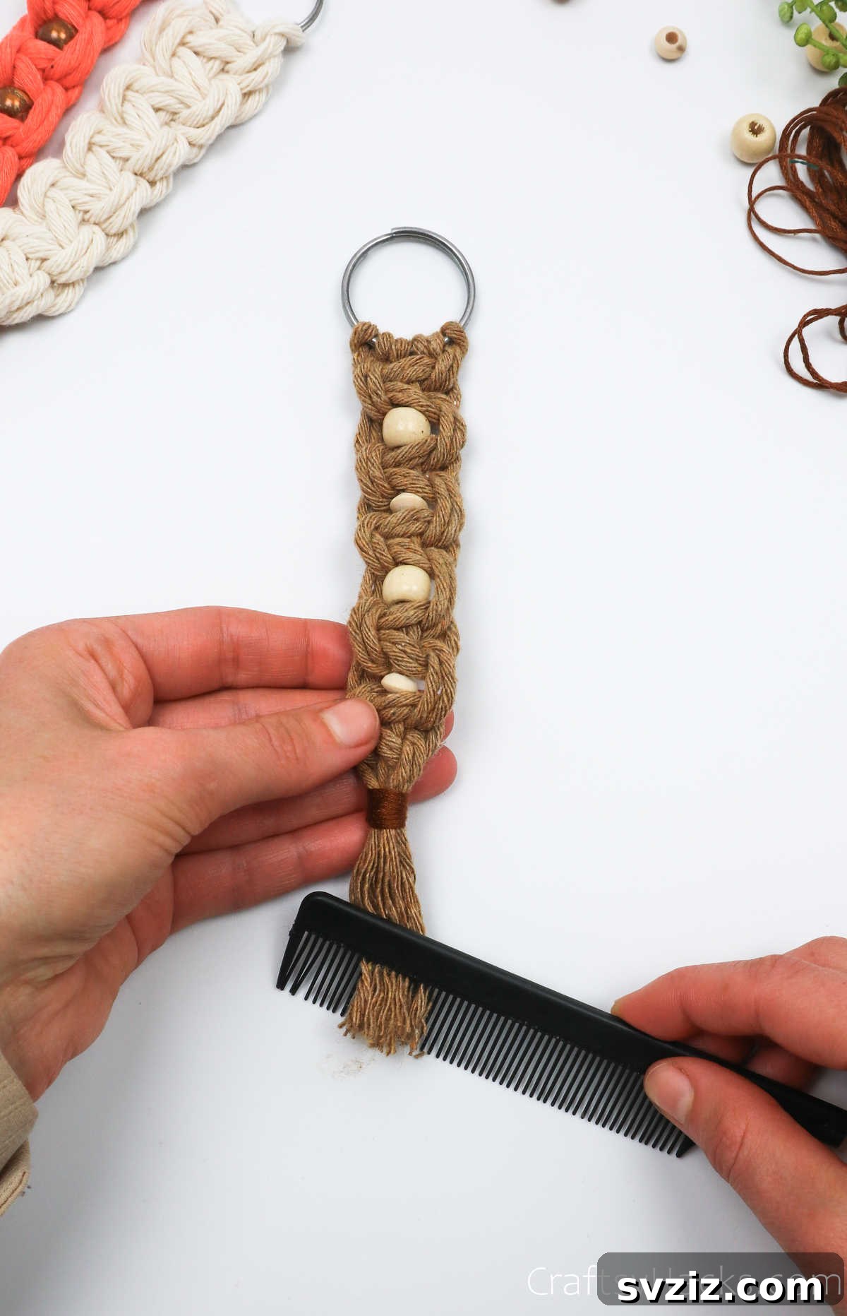Combing through the macrame cord ends to create a soft, fluffy tassel.