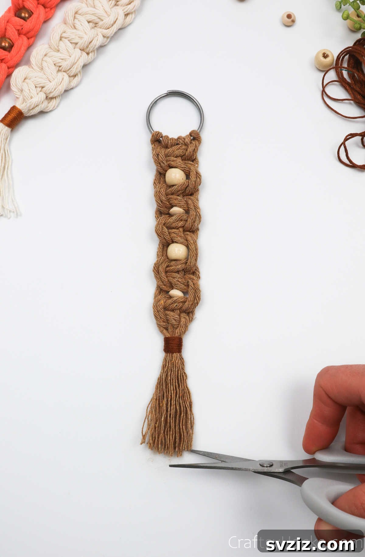 The final trimming of the macrame tassel after combing, ensuring a neat and polished look.