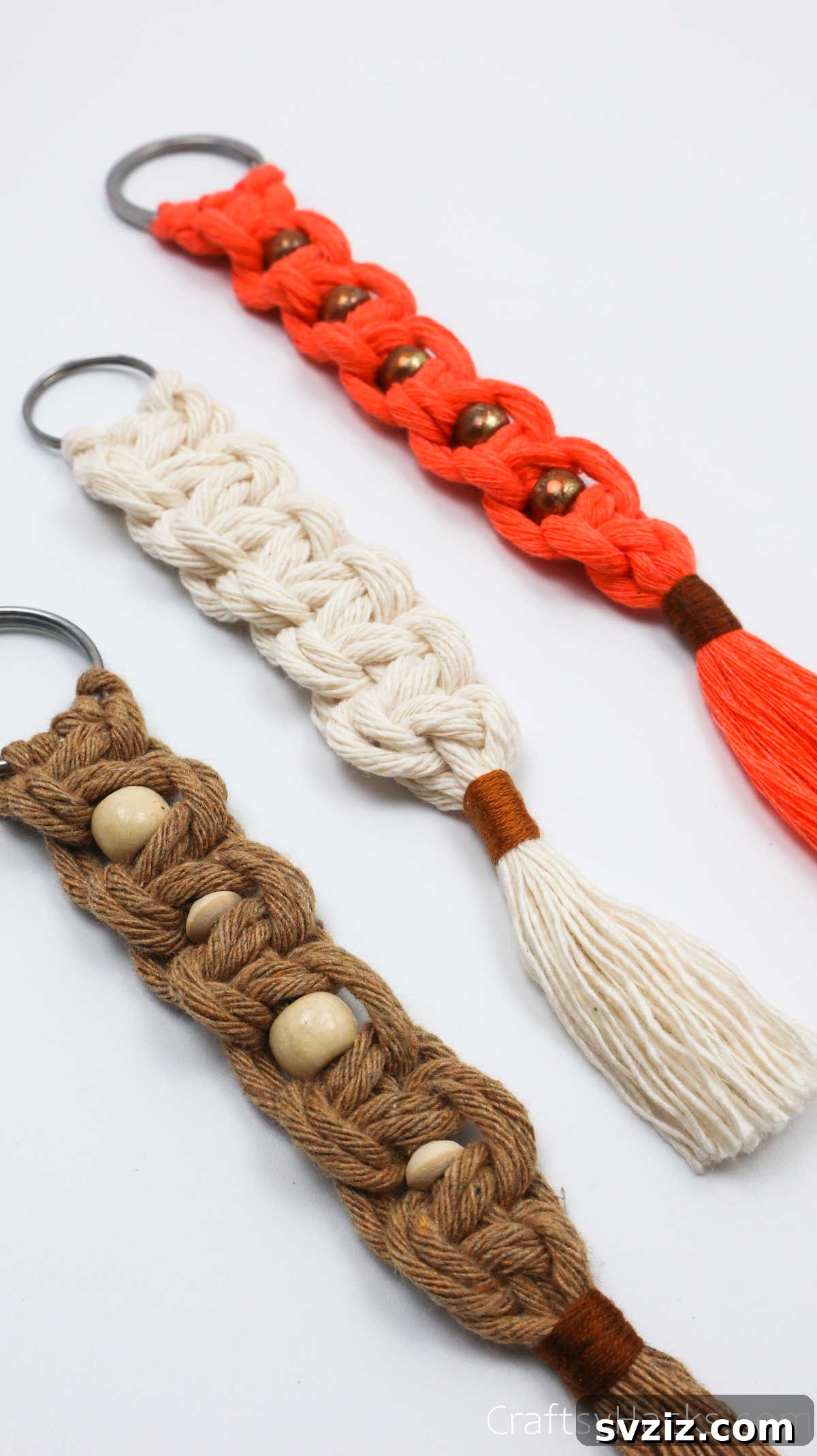 A pair of completed macrame keychains, showcasing the finished product with elegant tassels.