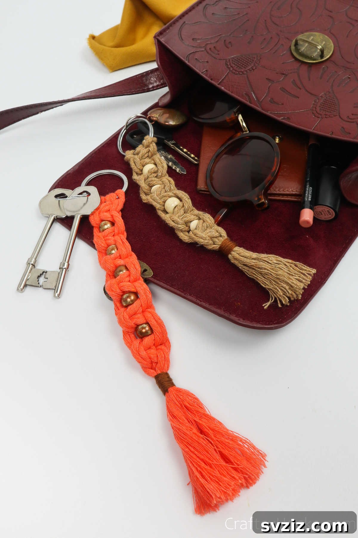 Several macrame keychains hanging from a purse, showing how they can accessorize bags.