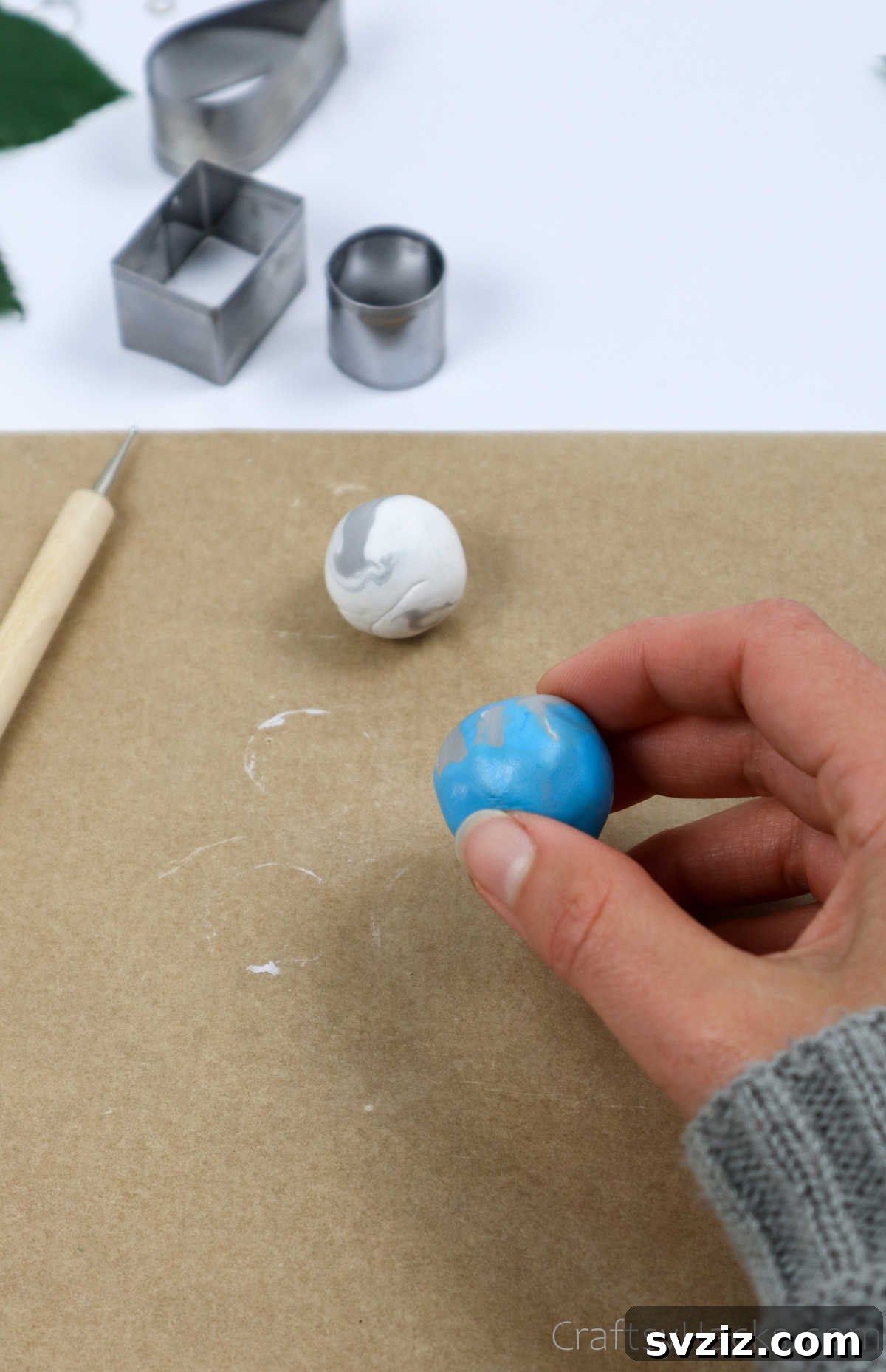 Craft Your Own Polymer Clay Earrings 28 Holding a conditioned ball of polymer clay