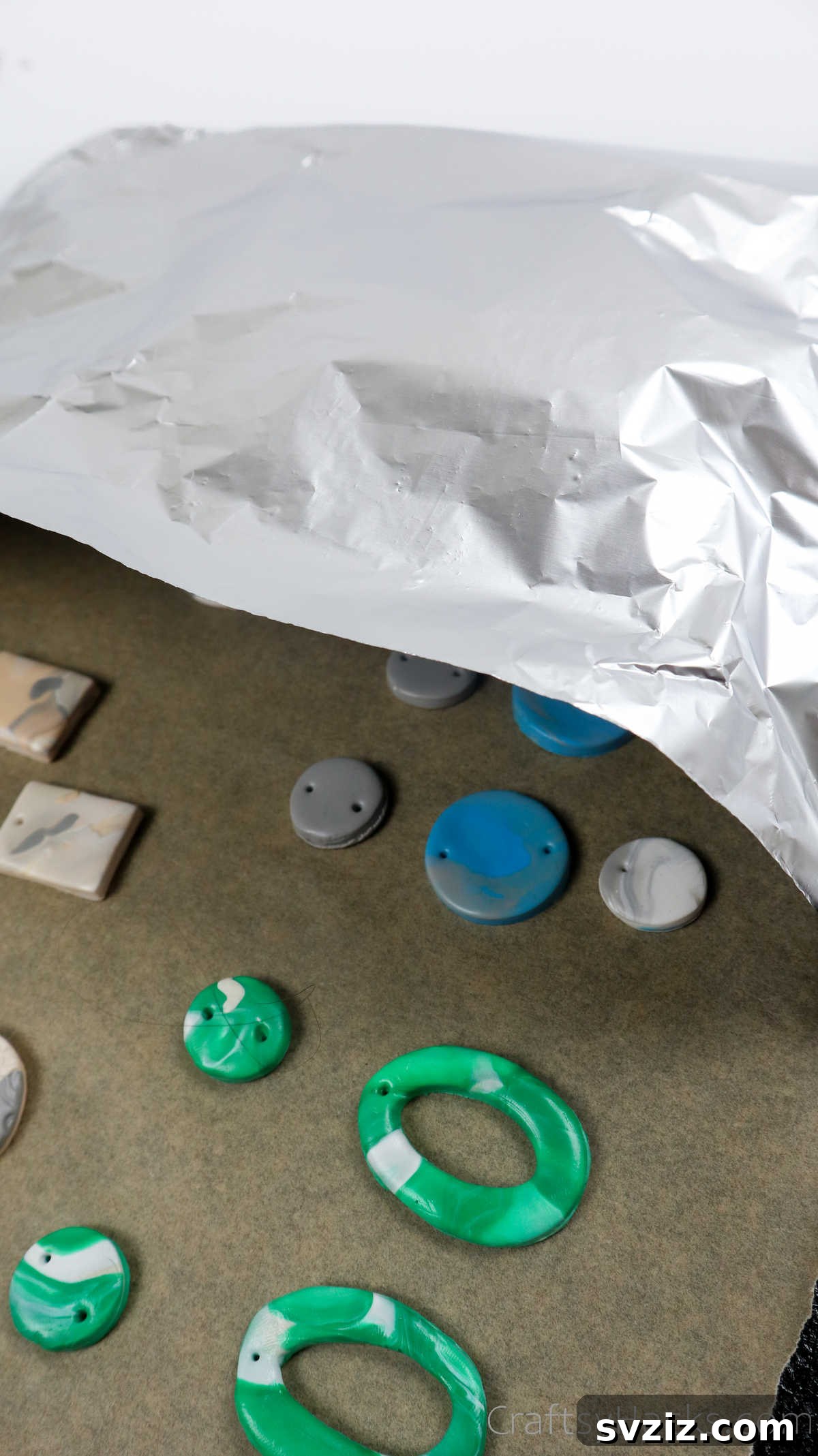 Craft Your Own Polymer Clay Earrings 53 Baking sheet with clay earrings covered in aluminum foil