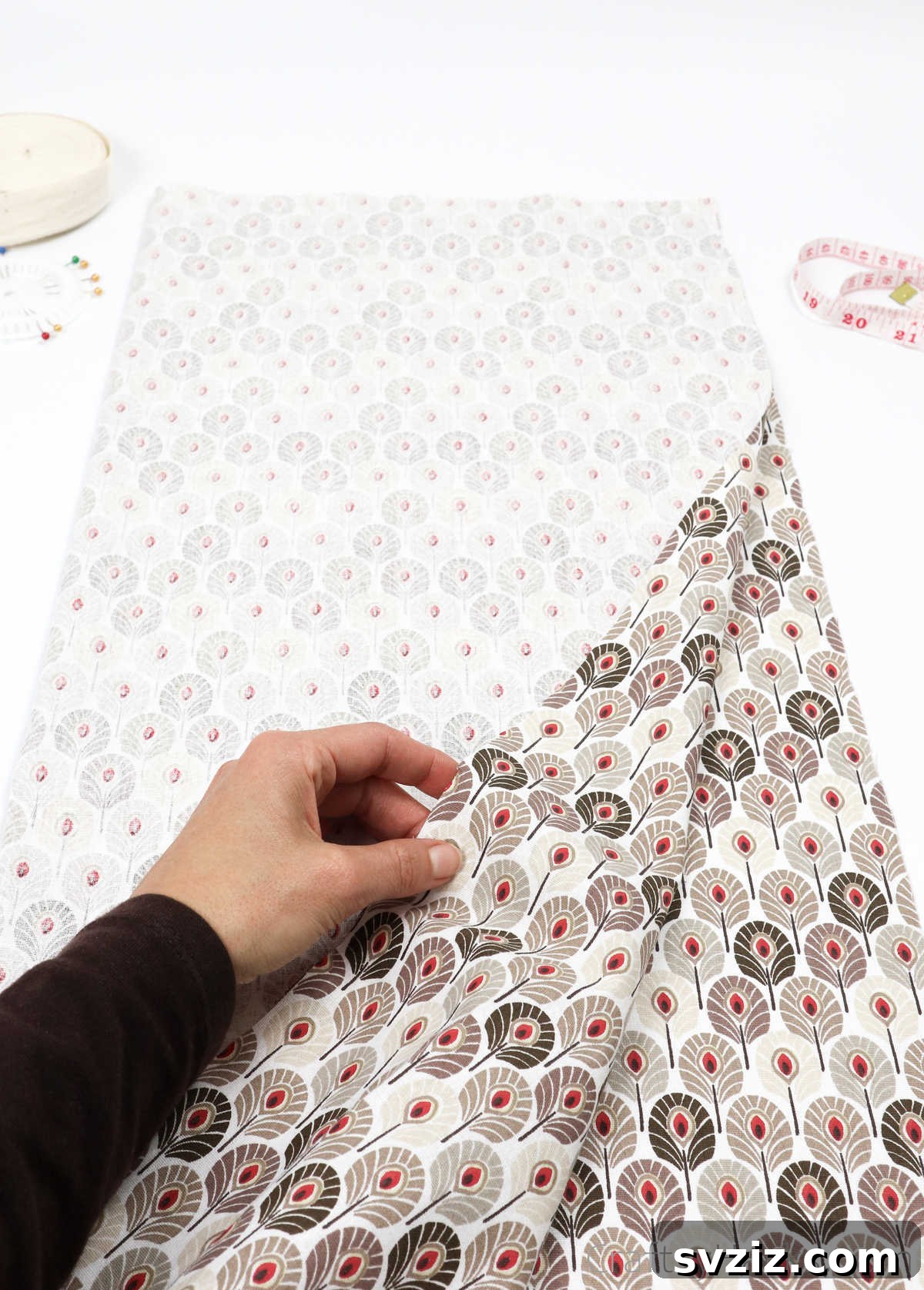 Craft Your Own Custom Apron 14 Holding a piece of beautifully patterned fabric, ready to be folded and cut for a unique DIY apron.