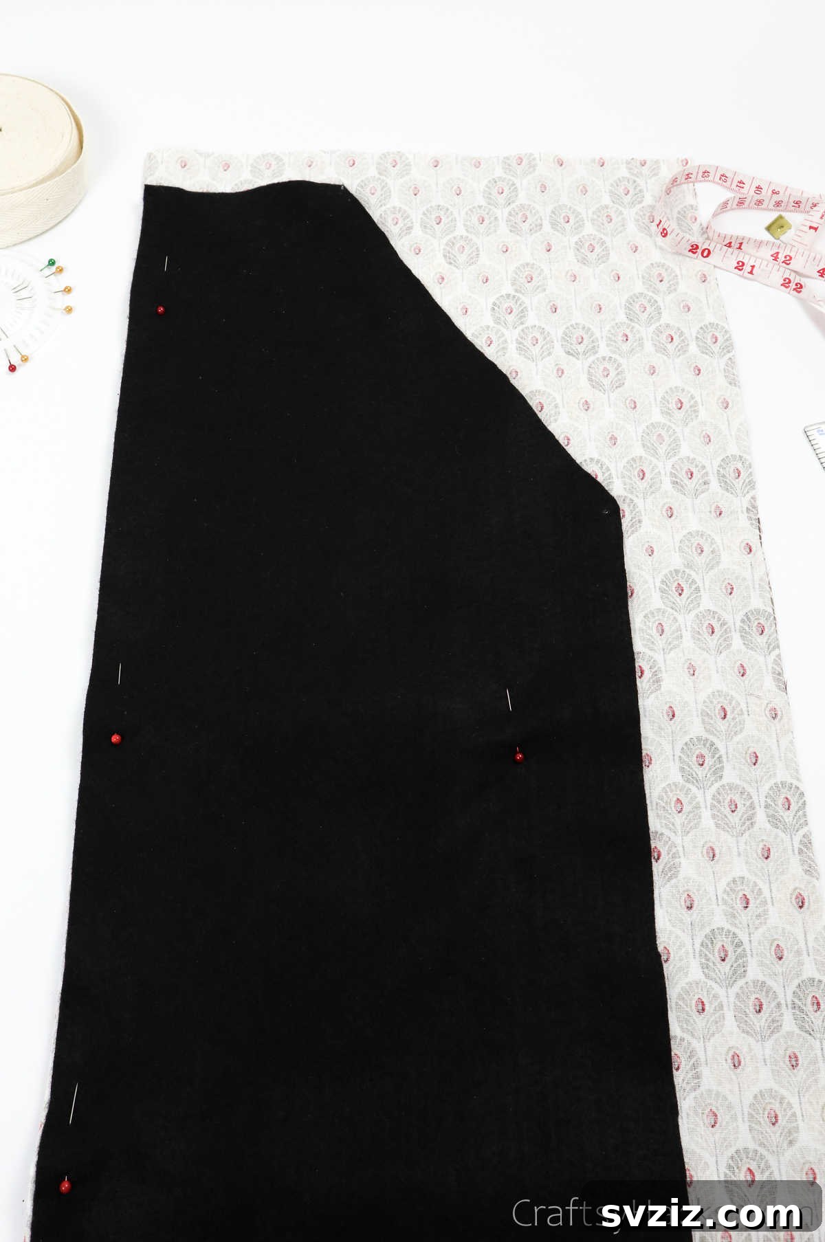 Craft Your Own Custom Apron 15 Pinning the fabric template to the main apron fabric, ensuring precise alignment and stability before tracing and cutting.