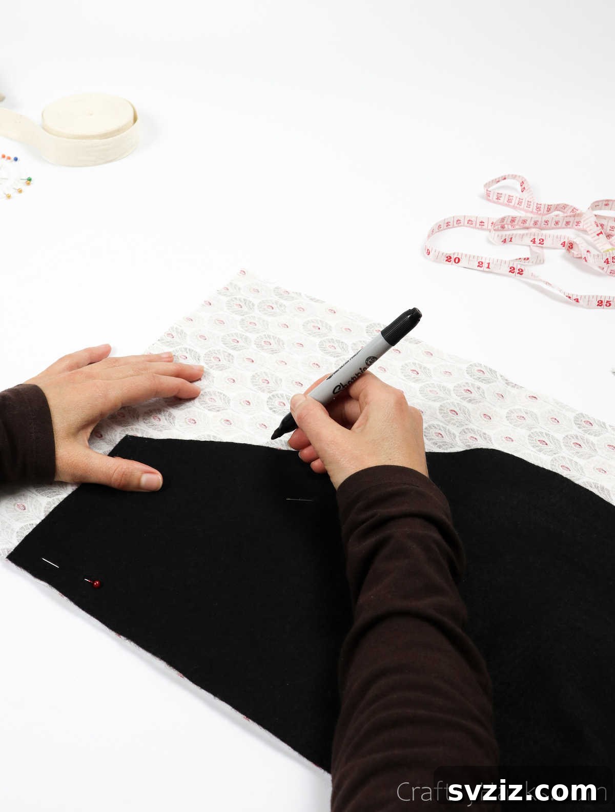 Craft Your Own Custom Apron 16 Tracing the apron pattern onto the main fabric with a sharpie, creating a clear guide for the next steps.