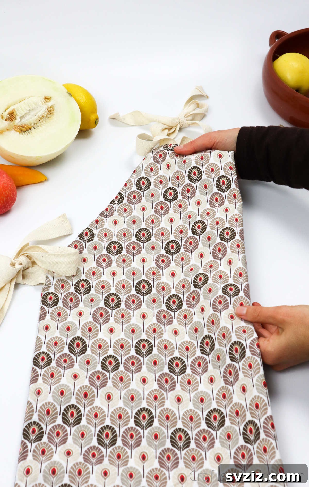Craft Your Own Custom Apron 3 Holding a neatly folded DIY apron, showcasing its potential as a perfect handmade gift or a practical sewing project for daily use.