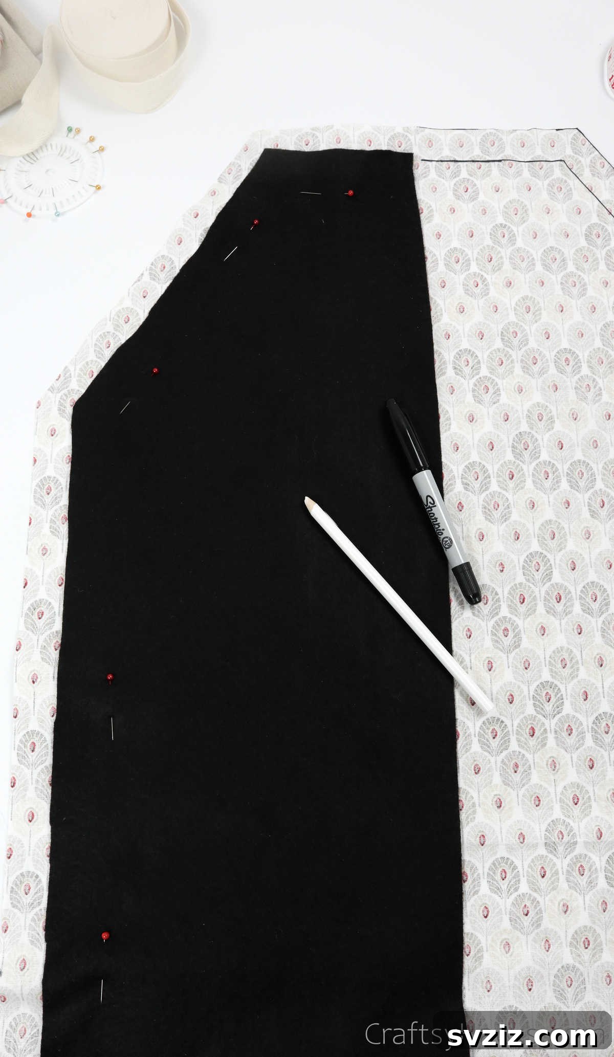 Craft Your Own Custom Apron 22 Pinning the black fabric template to the other side of the main apron fabric to ensure symmetrical markings and cutting.