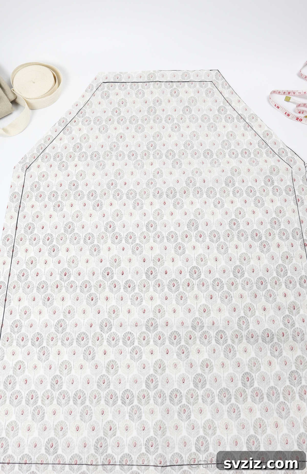 Craft Your Own Custom Apron 23 A crisp black outline meticulously drawn around the main fabric, marking the exact shape and seam allowance for the DIY apron.