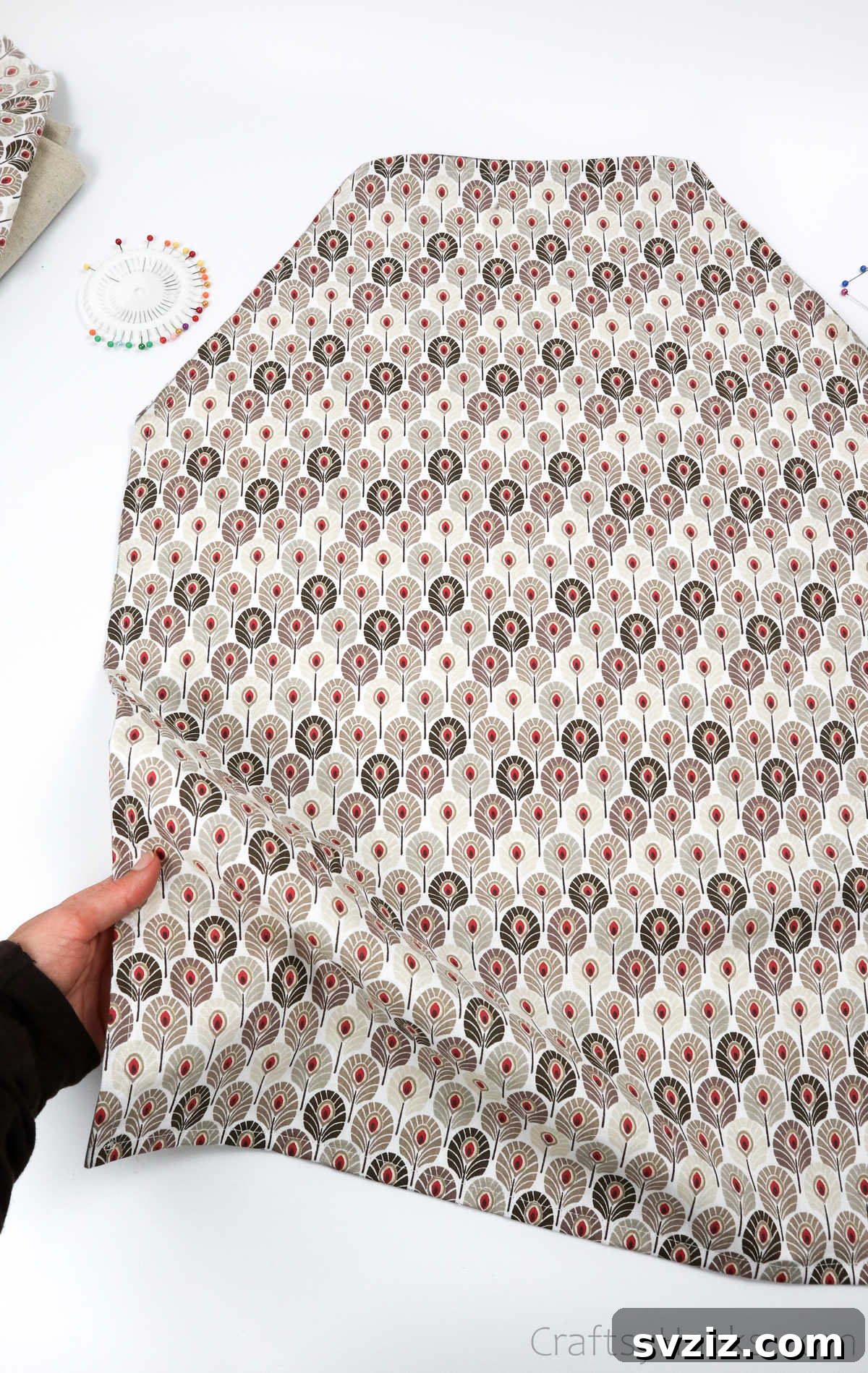 Craft Your Own Custom Apron 27 Holding the fabric, the apron's shape is beginning to take form with well-pressed and pinned hems.