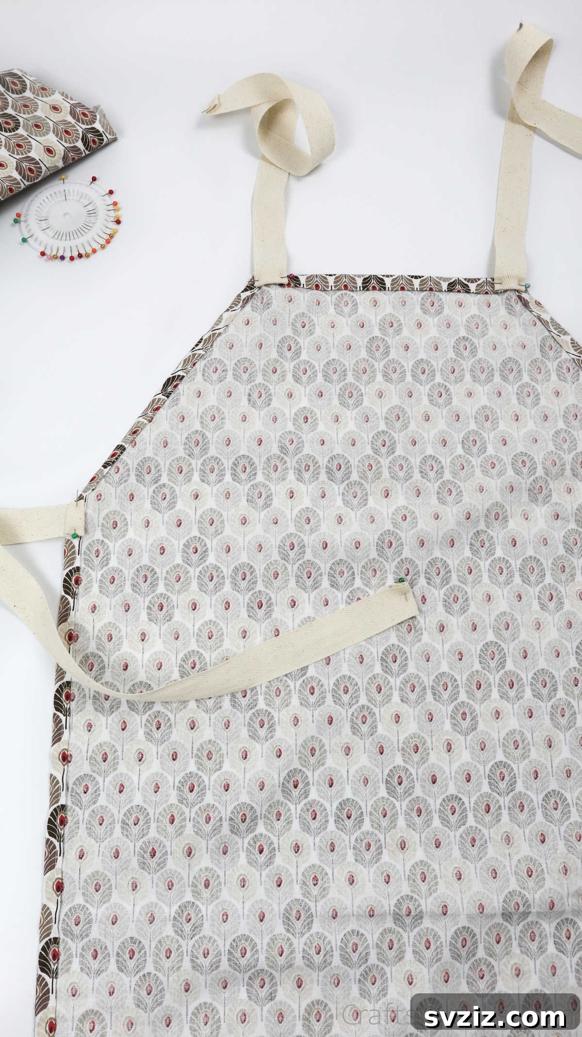 Craft Your Own Custom Apron 32 Securely pinning ribbon straps to the apron, positioning two at the neck and two at the waist for a well-fitted design.