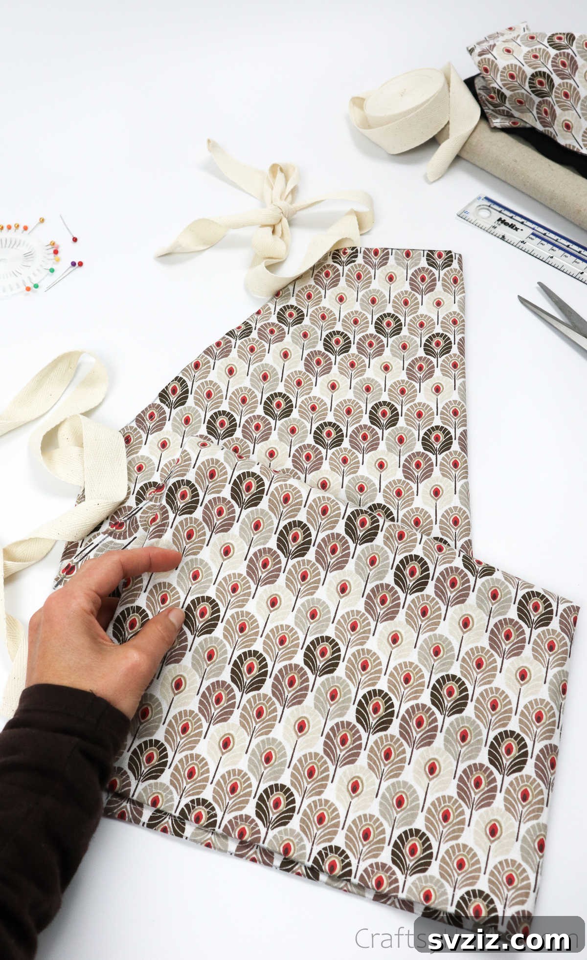 Craft Your Own Custom Apron 37 Holding a beautifully completed DIY apron, a lovely handmade item perfect for personal use or as a unique gift, offering both style and functionality.