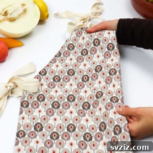 A vibrant, handcrafted apron with contrasting patterns, folded neatly, perfect for kitchen tasks or as a thoughtful gift.