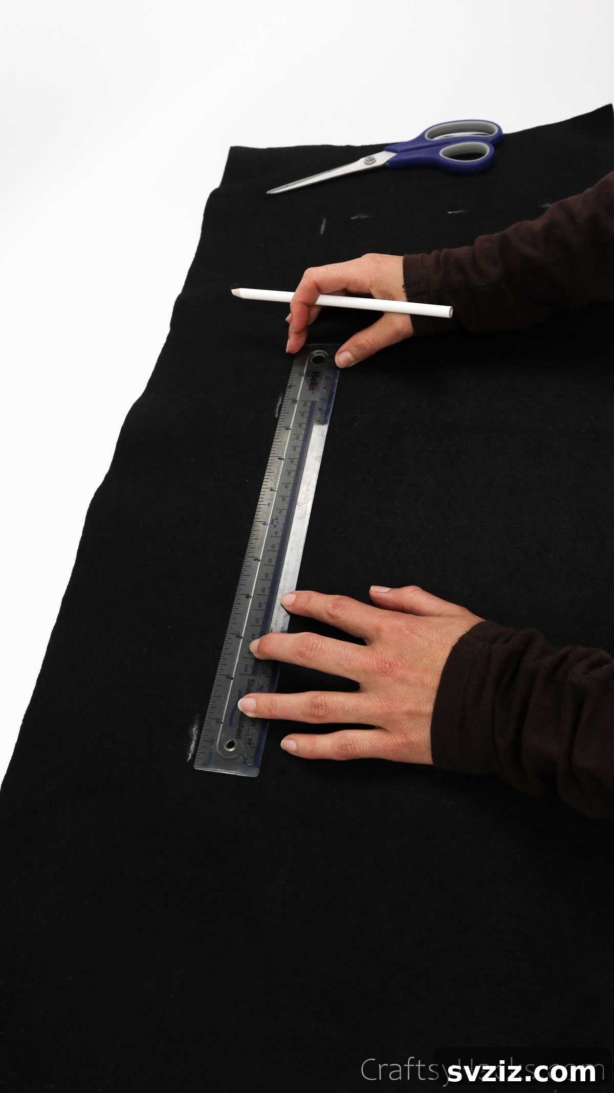 Craft Your Own Custom Apron 9 Connecting marked points with a ruler to form the precise outline of a DIY apron on fabric.