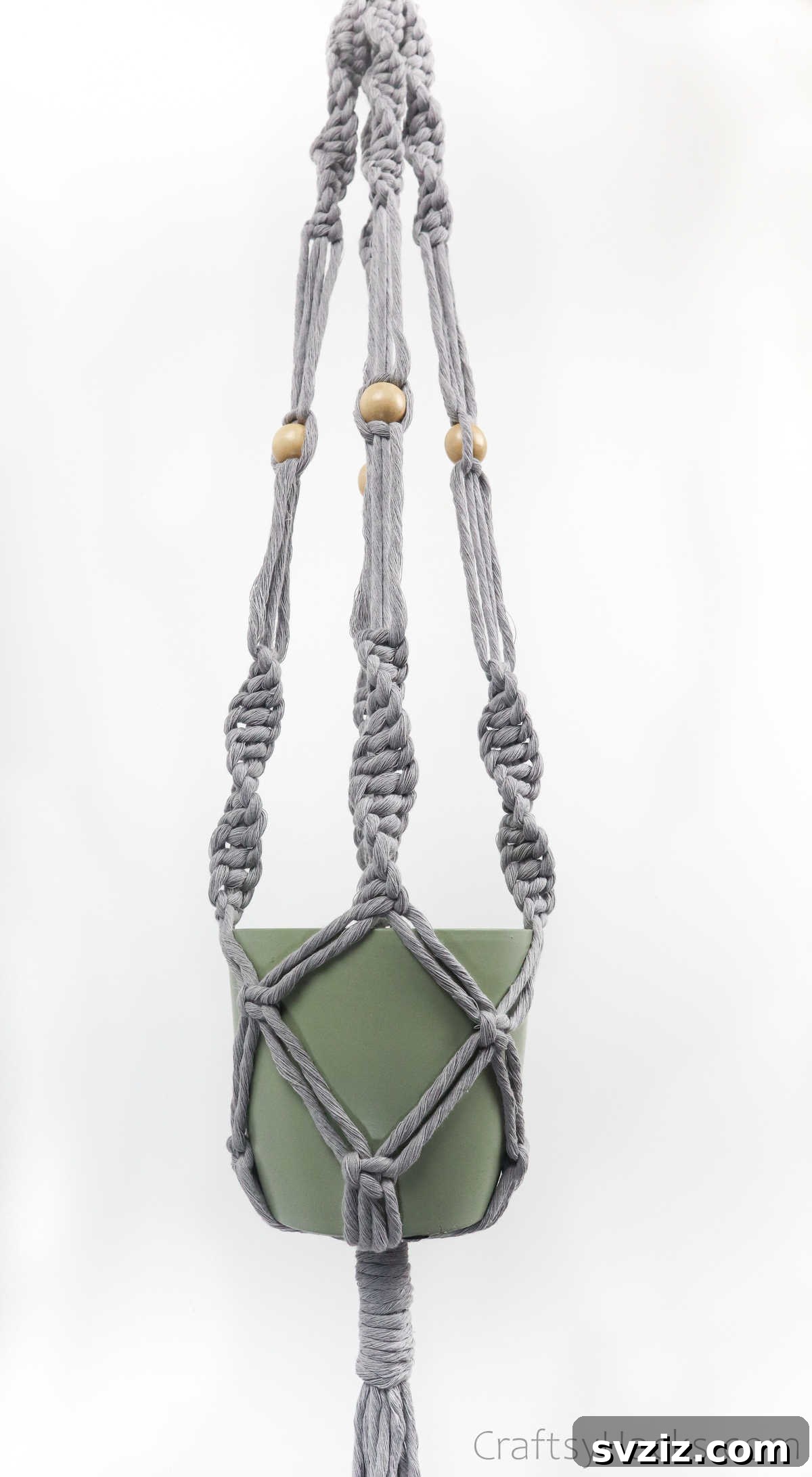 Craft Your Own Macrame Plant Hanger A Complete Guide 13 A beautifully finished macrame plant hanger, empty and ready for a plant, showcasing its intricate design.