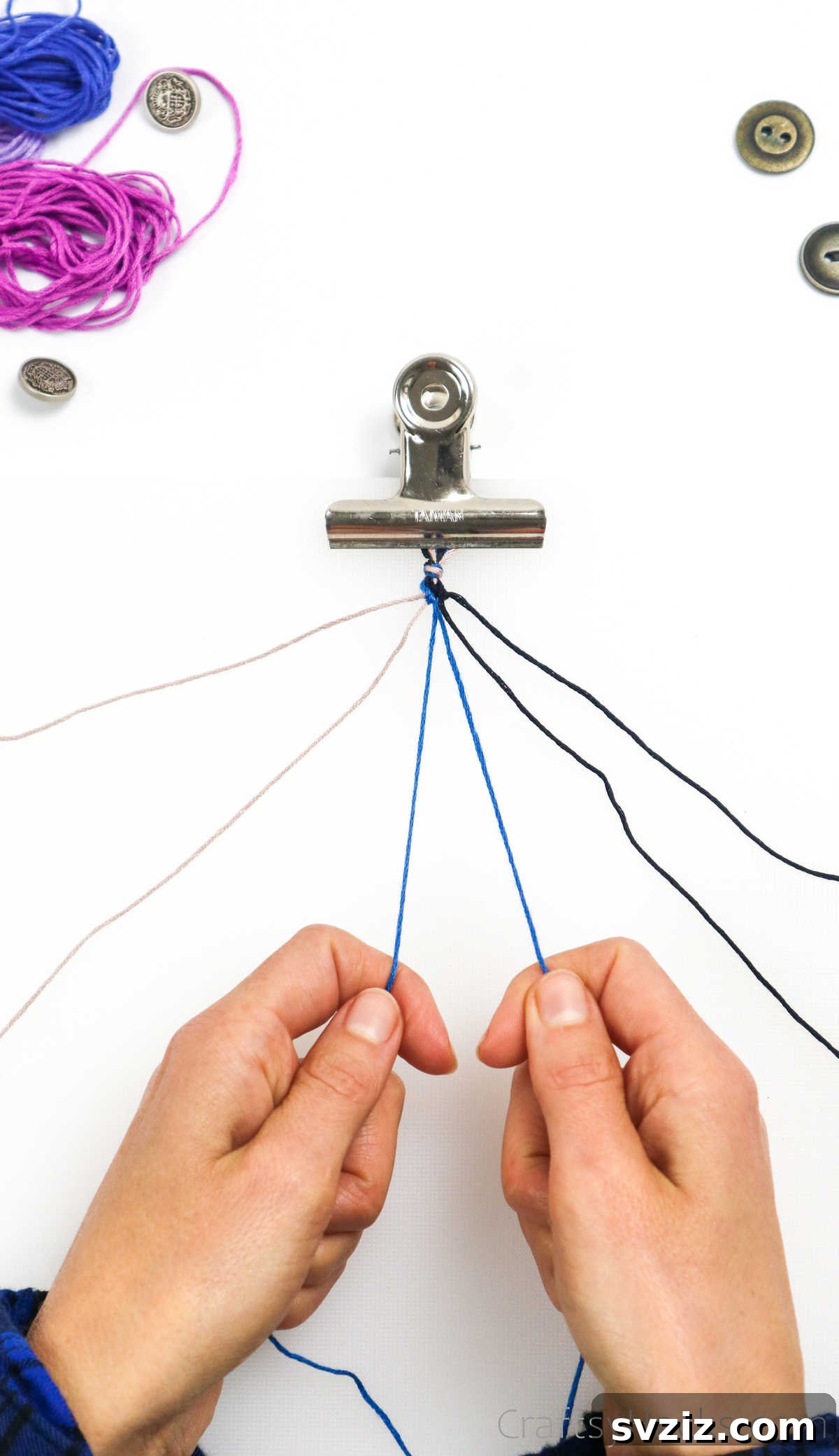 Crafting Friendship Bracelets 29 holding blue thread