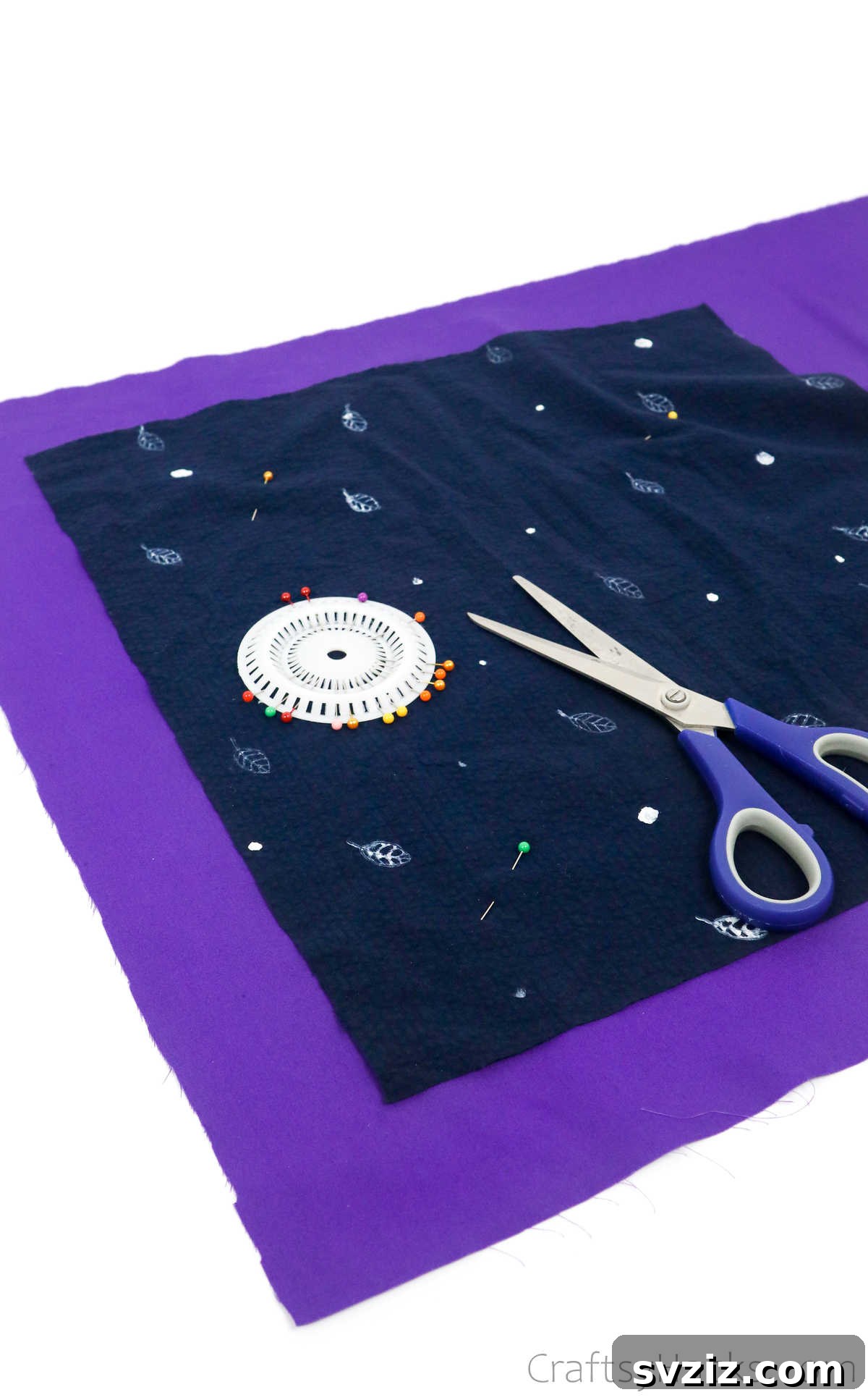 Pinning a cut shirt fabric onto lining material, ensuring precise alignment for cutting