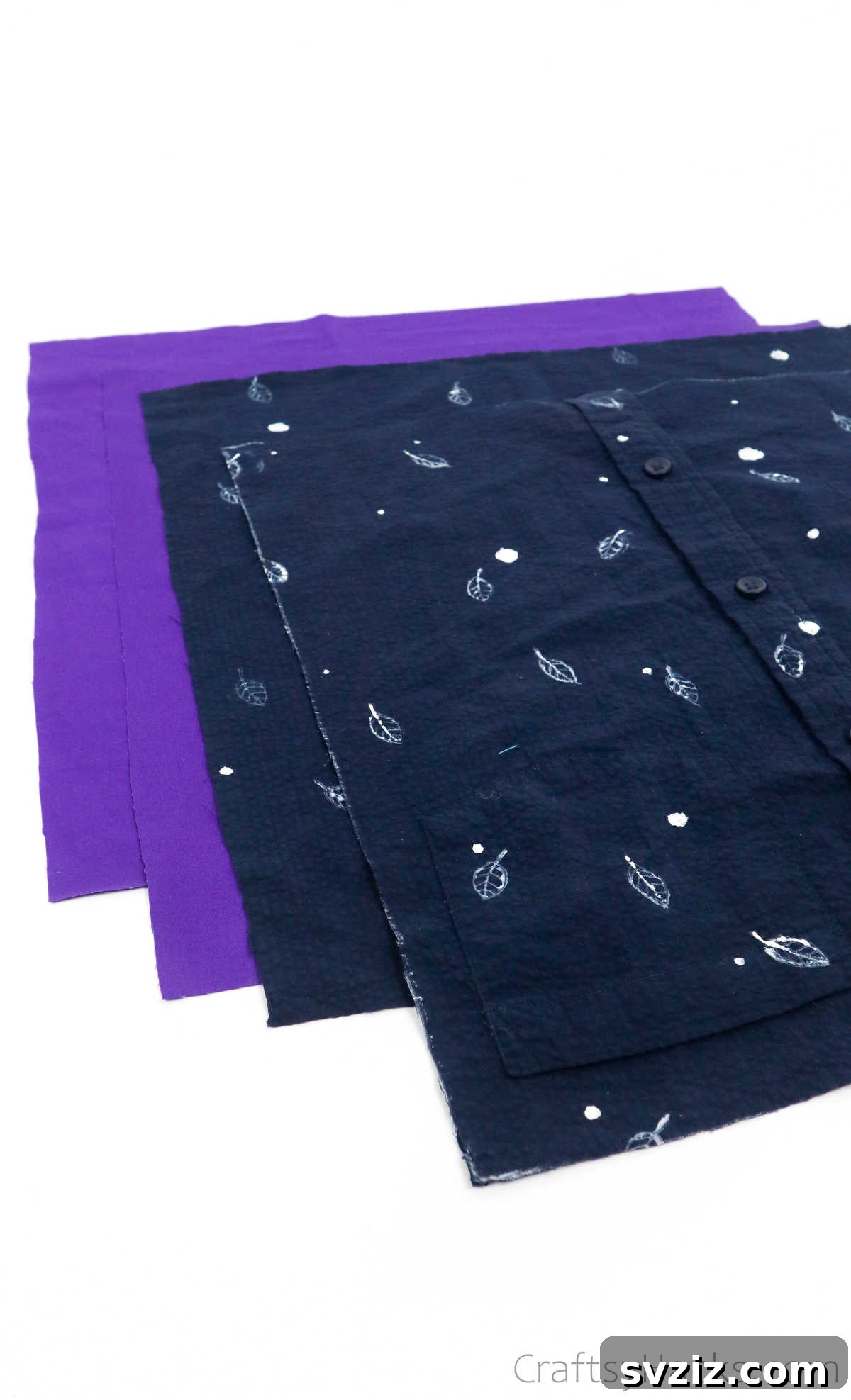 Four cut fabric squares, two outer and two lining, neatly stacked for tote bag assembly