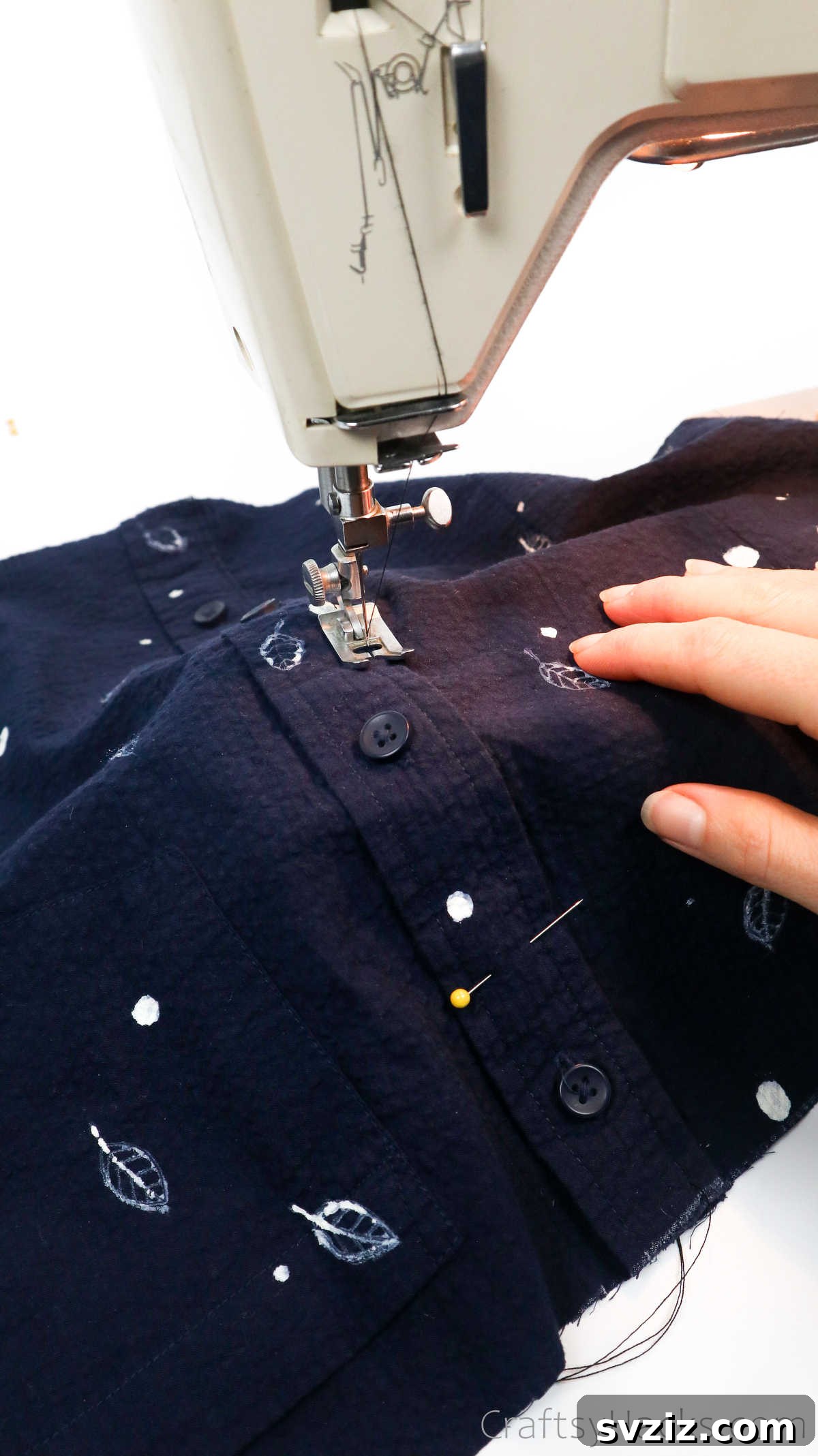 Sewing machine stitching along a shirt's button placket to secure it for a DIY tote bag