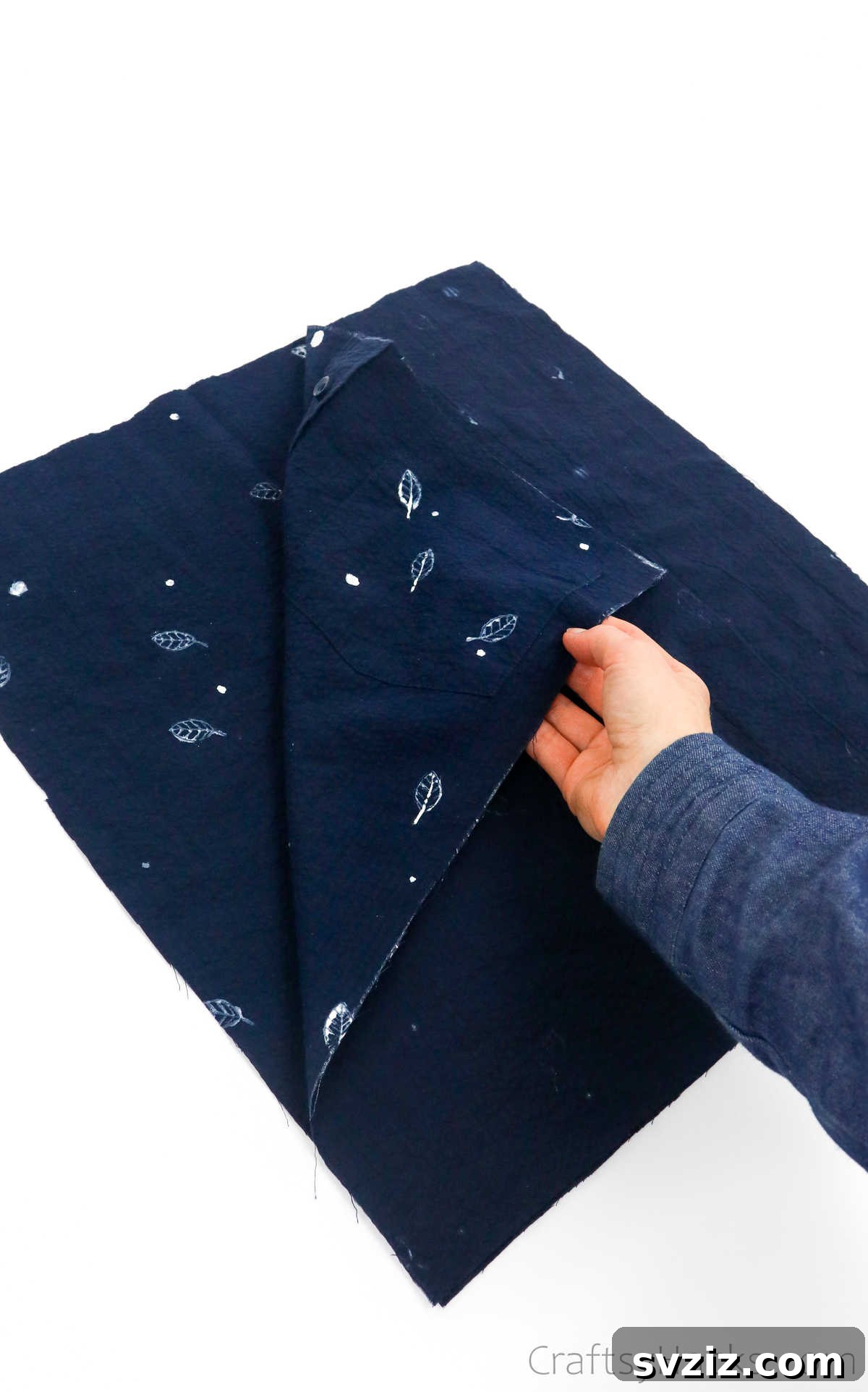 Folding shirt fabric right sides together, preparing for sewing a tote bag