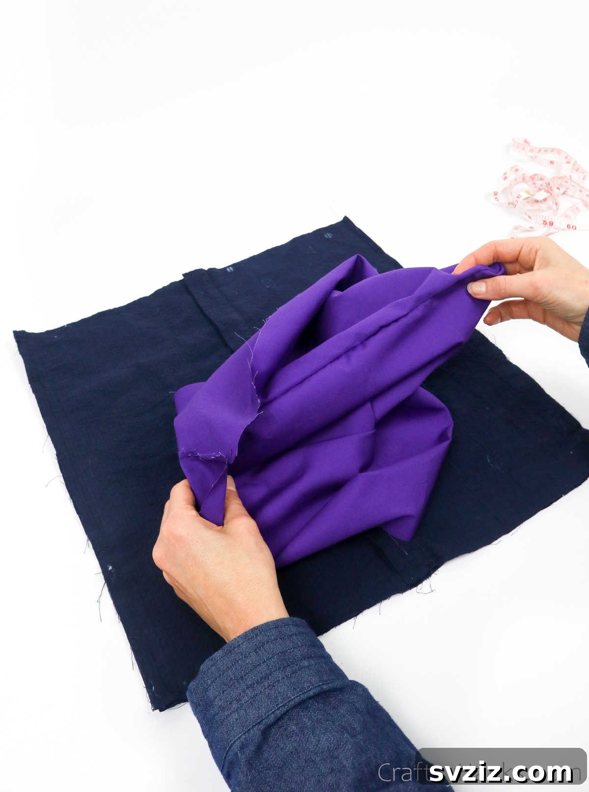 Turning the lining fabric of the tote bag right side out, revealing a neat finish