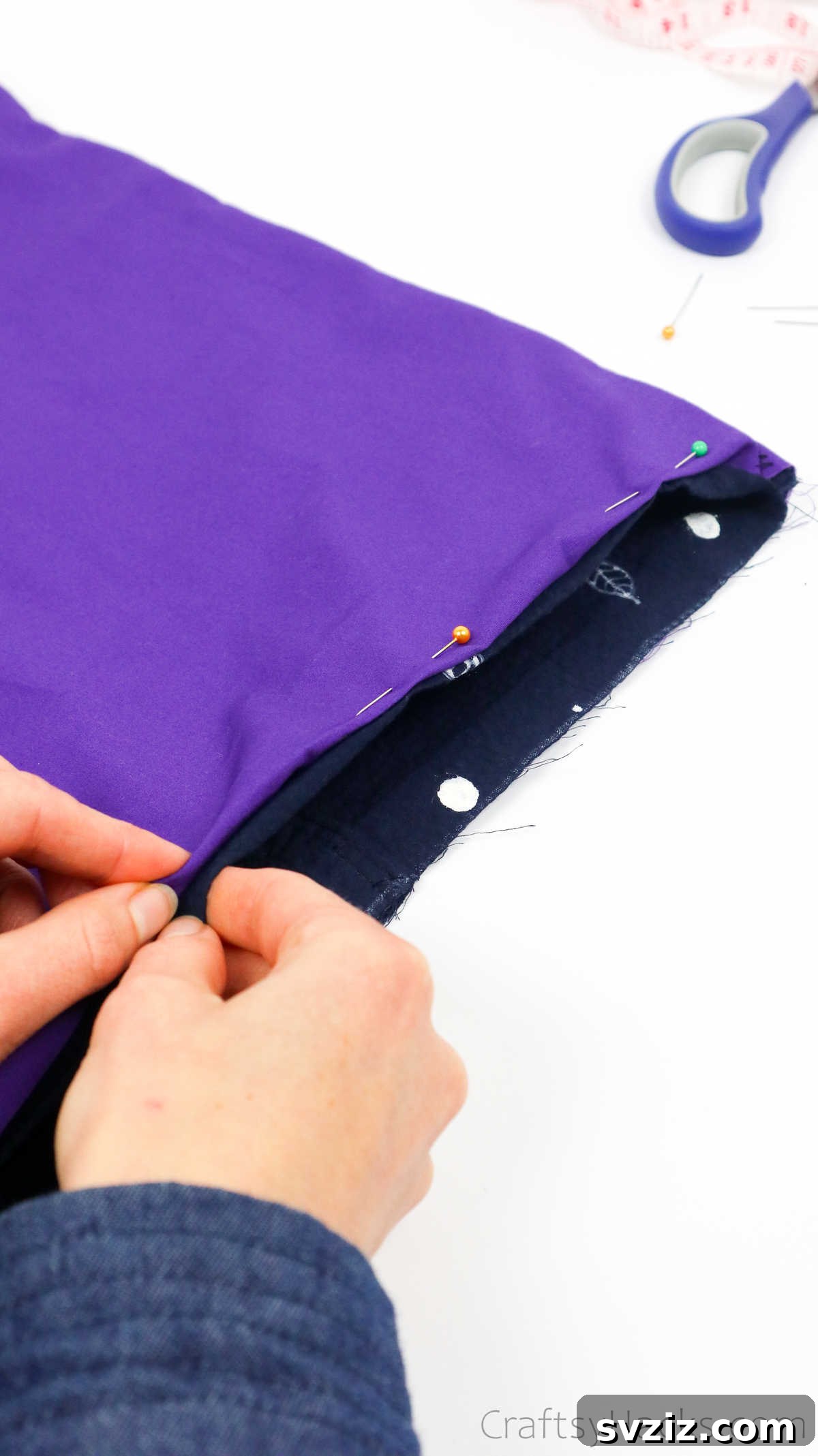 Close-up of pinned fabric along the tote bag's rim, ensuring a smooth and even finish