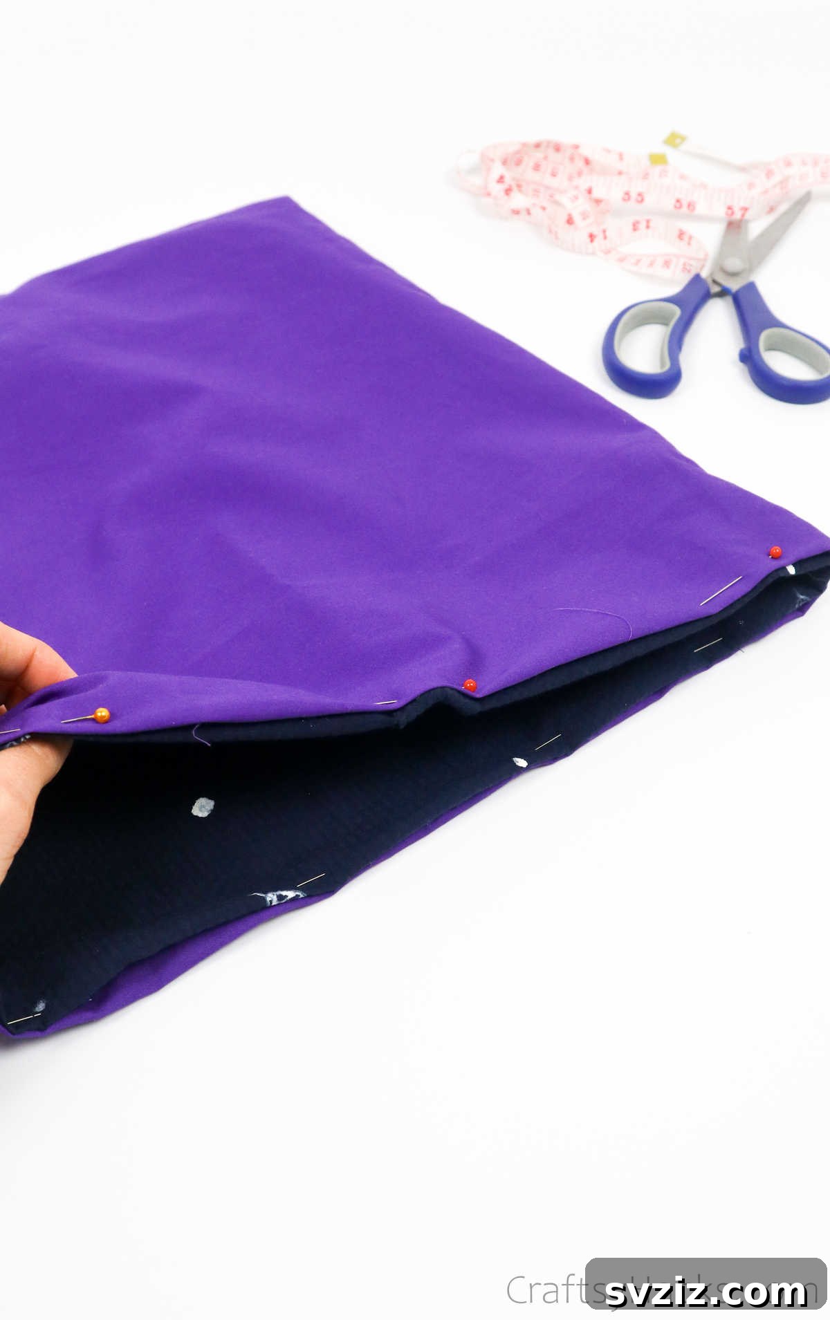 The entirely pinned rim of the tote bag, showing precise folding and alignment for sewing