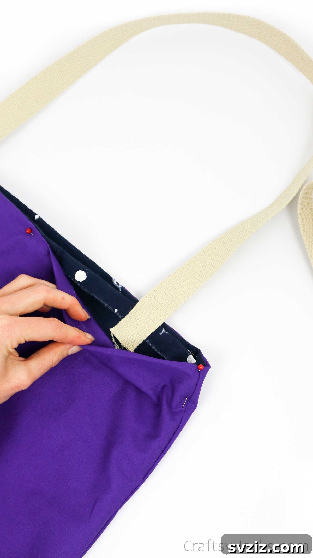 Pinning a strap end between the outer fabric and lining of the tote bag, securing it in place