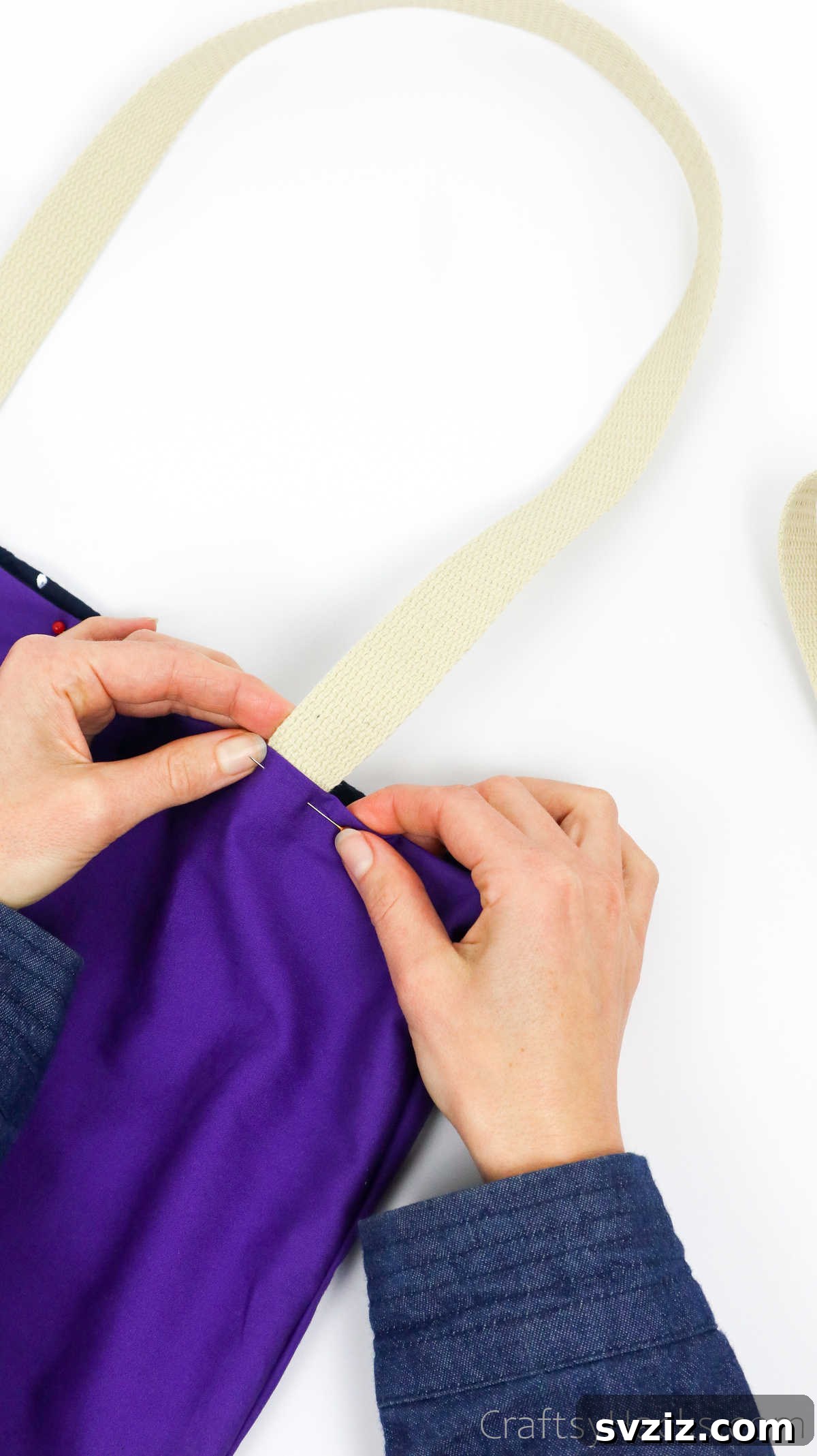 Securing the second strap end with pins, ensuring both straps are even and properly positioned