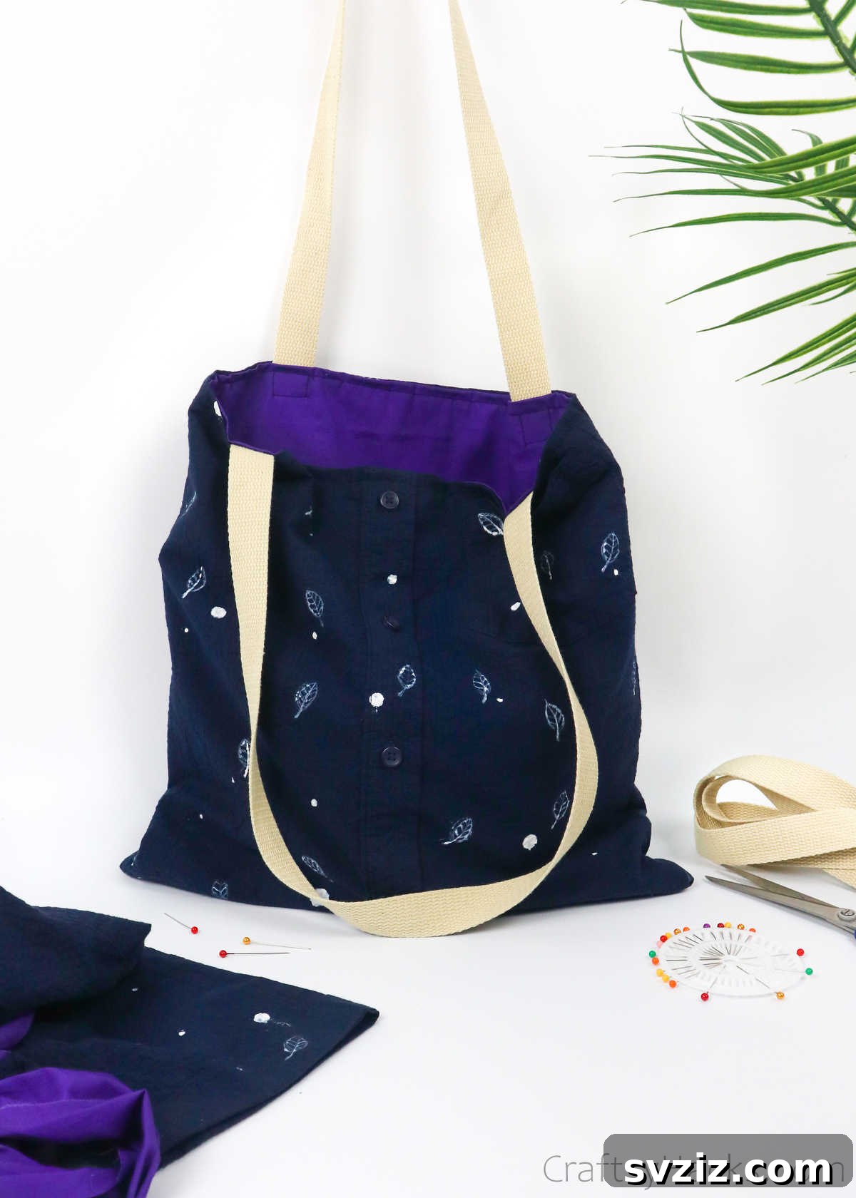 A completed DIY tote bag from an old shirt, elegantly hung, showcasing its design and utility
