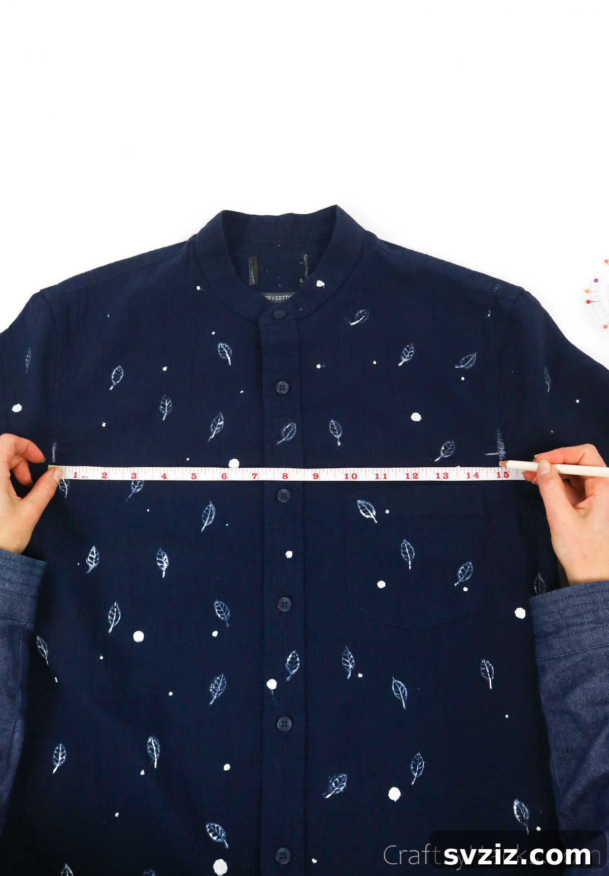 Measuring the width of a shirt with a tape measure, crucial for accurate tote bag dimensions