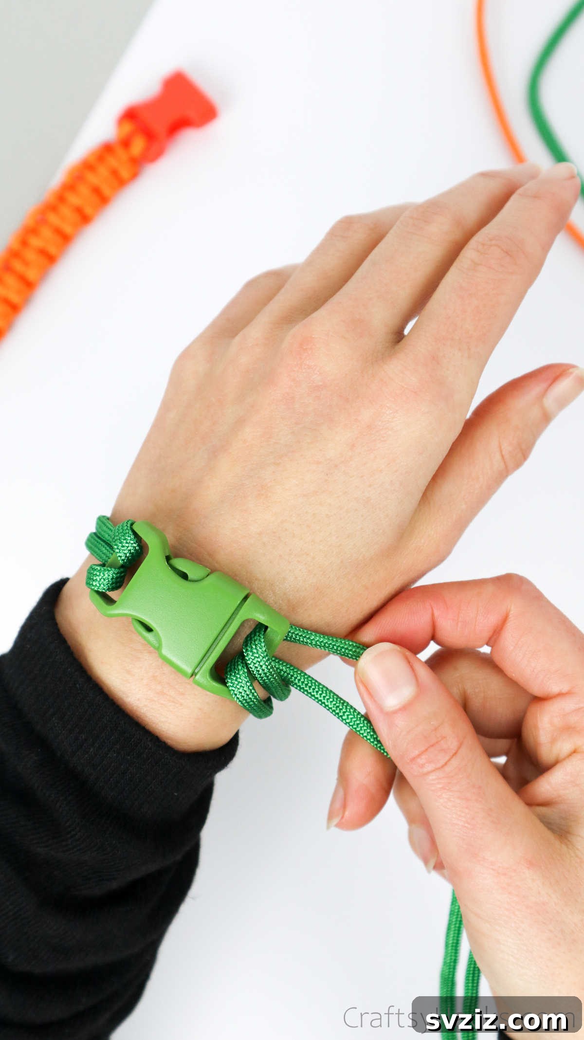 A person measuring the paracord bracelet on their wrist, ensuring a perfect, comfortable fit before knotting.