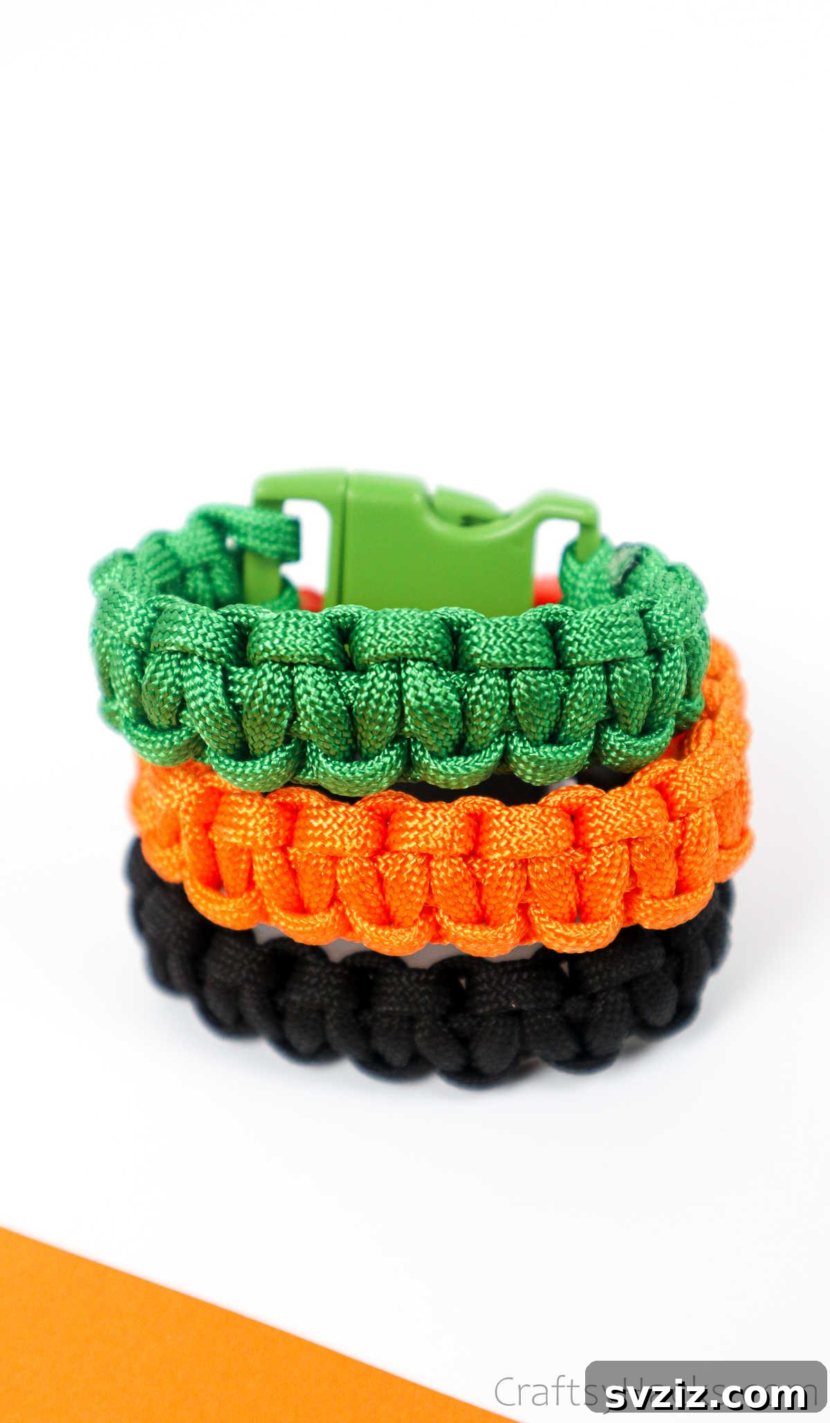 A hand modeling a stack of beautifully crafted paracord bracelets in various complementary colors.