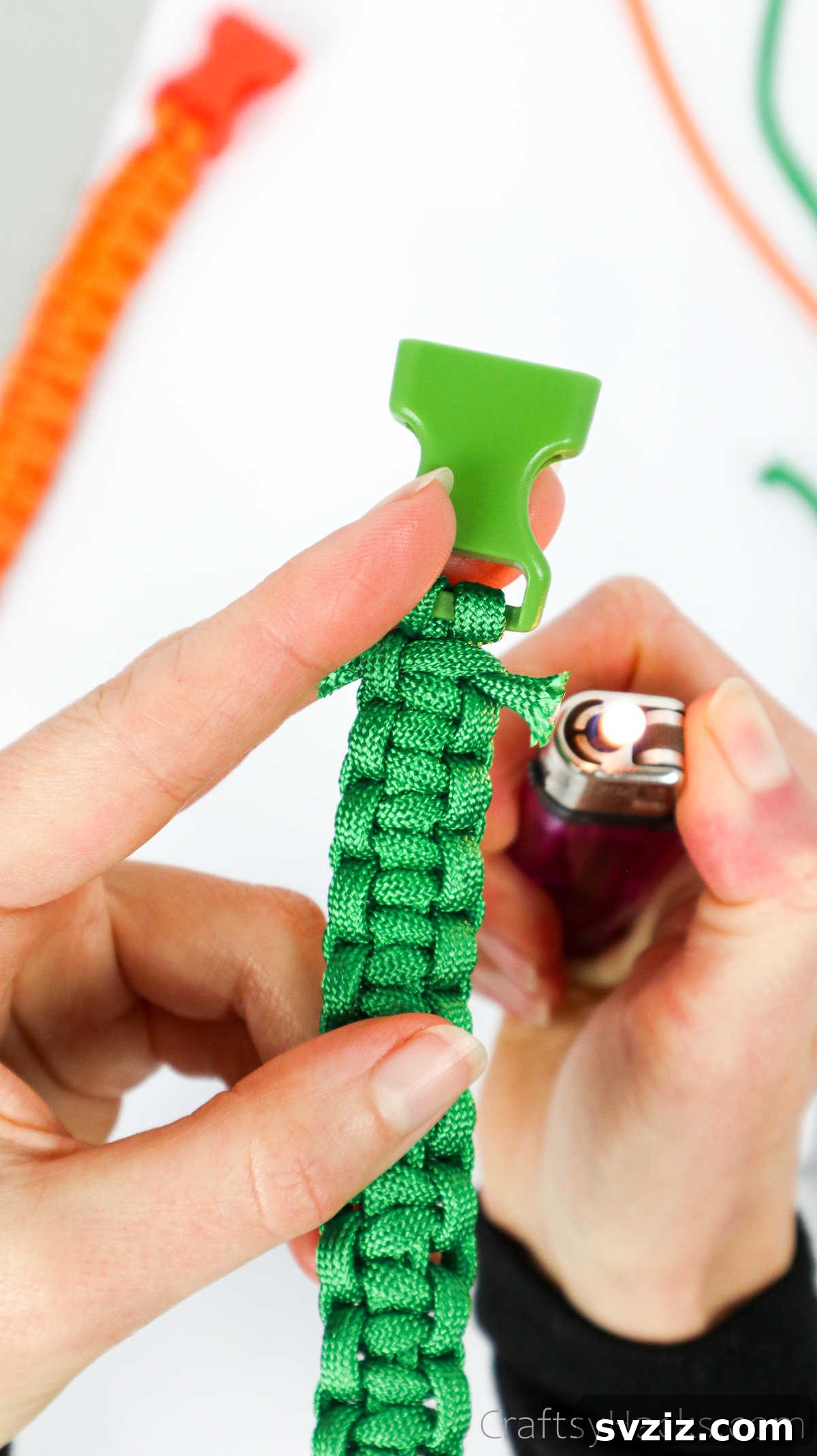 A lighter flame carefully applied to the trimmed paracord ends on the bracelet, sealing them.