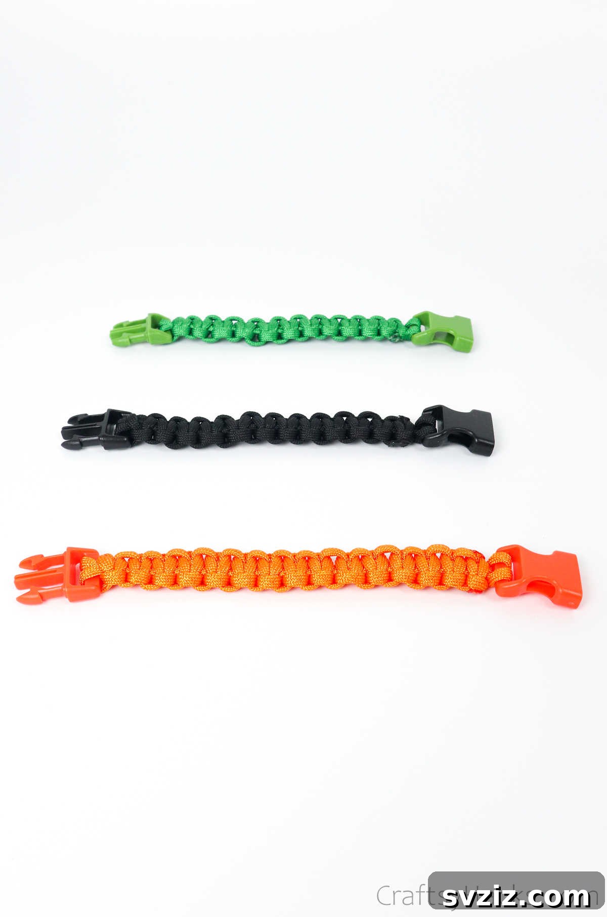 A vibrant collection of three finished paracord bracelets in different colors, showcasing the completed weave.